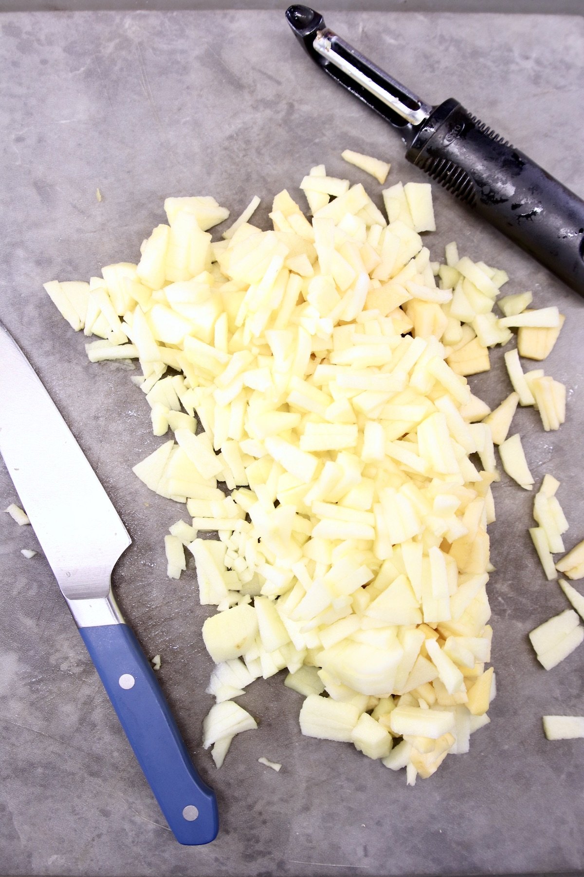 diced apples with peeler and knife
