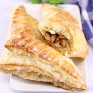 apple turnovers on a plate - one with filling showing