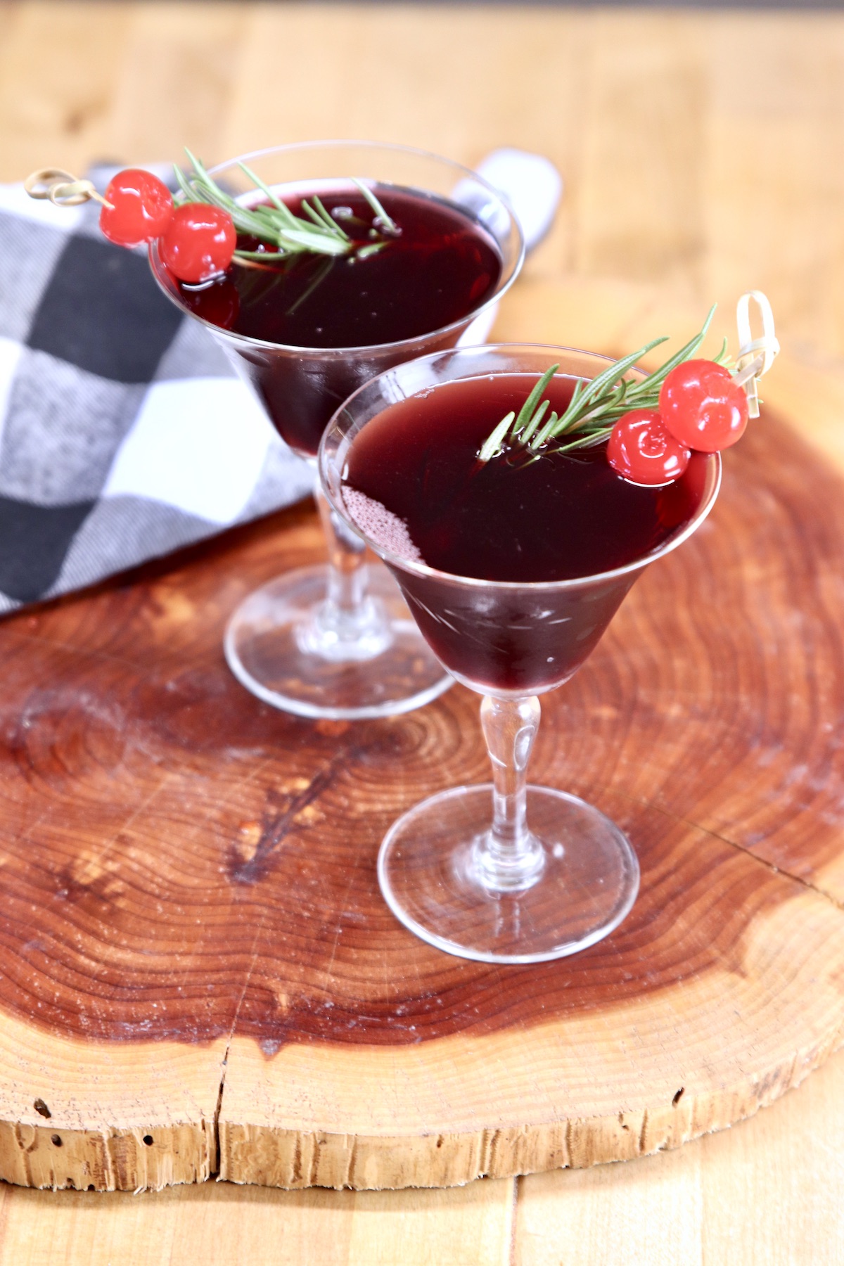 Amaretto Wine Cocktail 2 glasses -cherry garnish on wood board