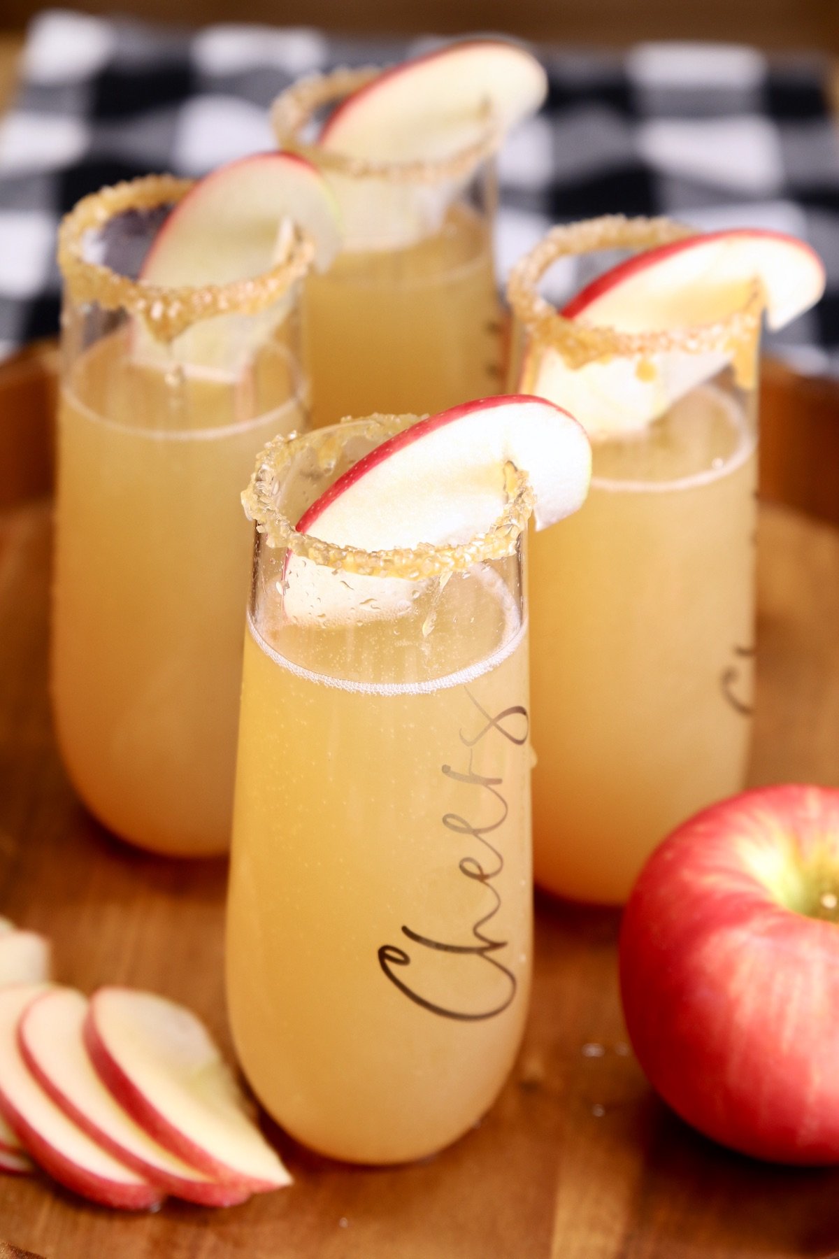 4 apple cider mimosas with apple garnish
