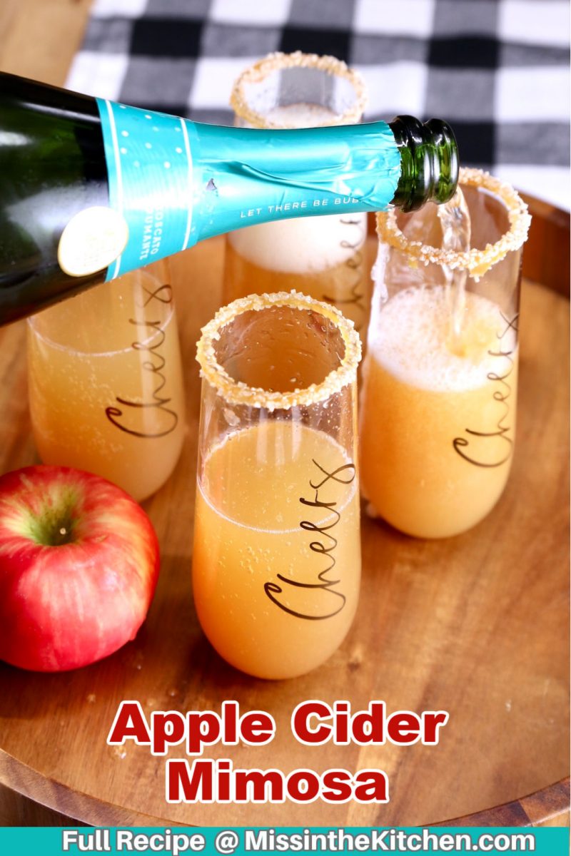 pouring champagne into apple cider filled glasses