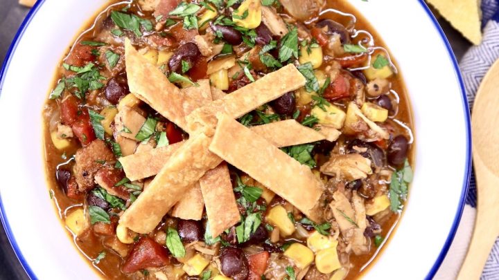 Chicken tortilla soup in a bowl topped with crispy tortilla strips