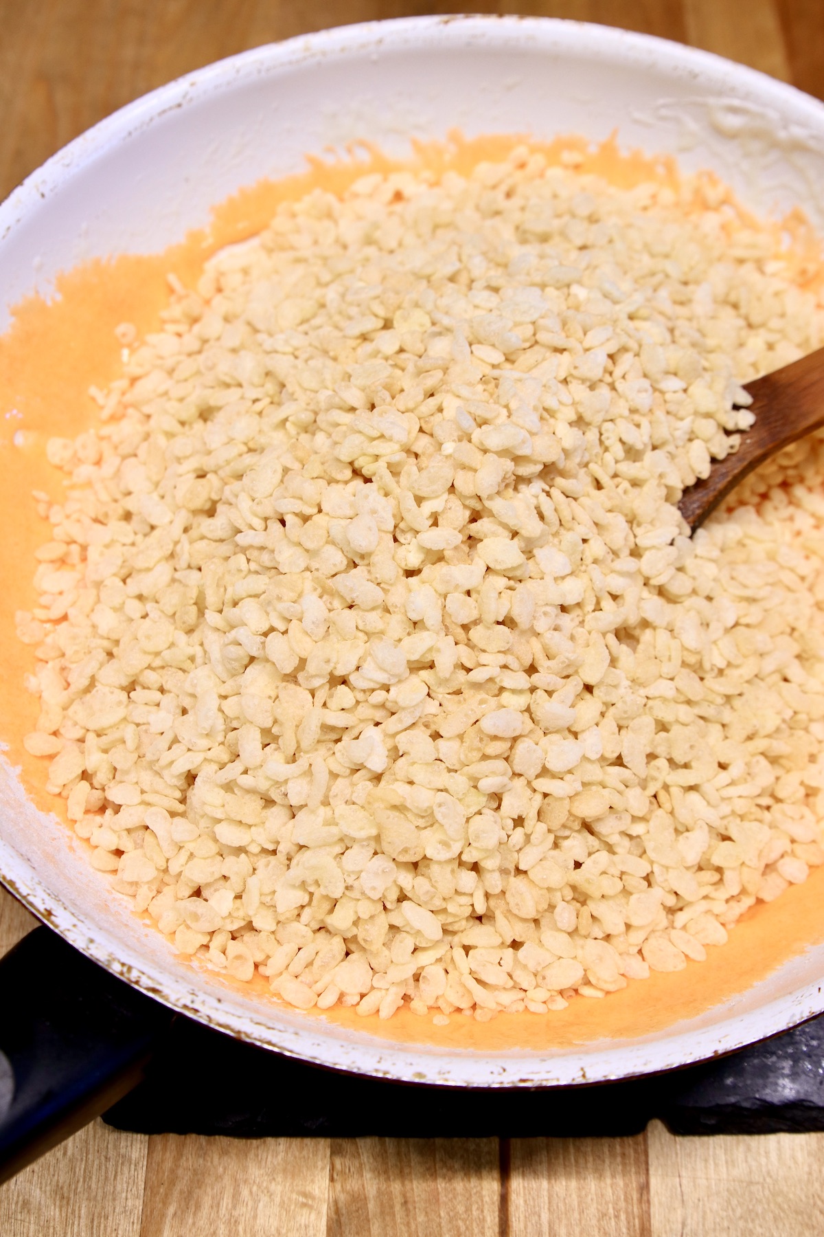rice krispies cereal in a pan with orange marshmallow cream