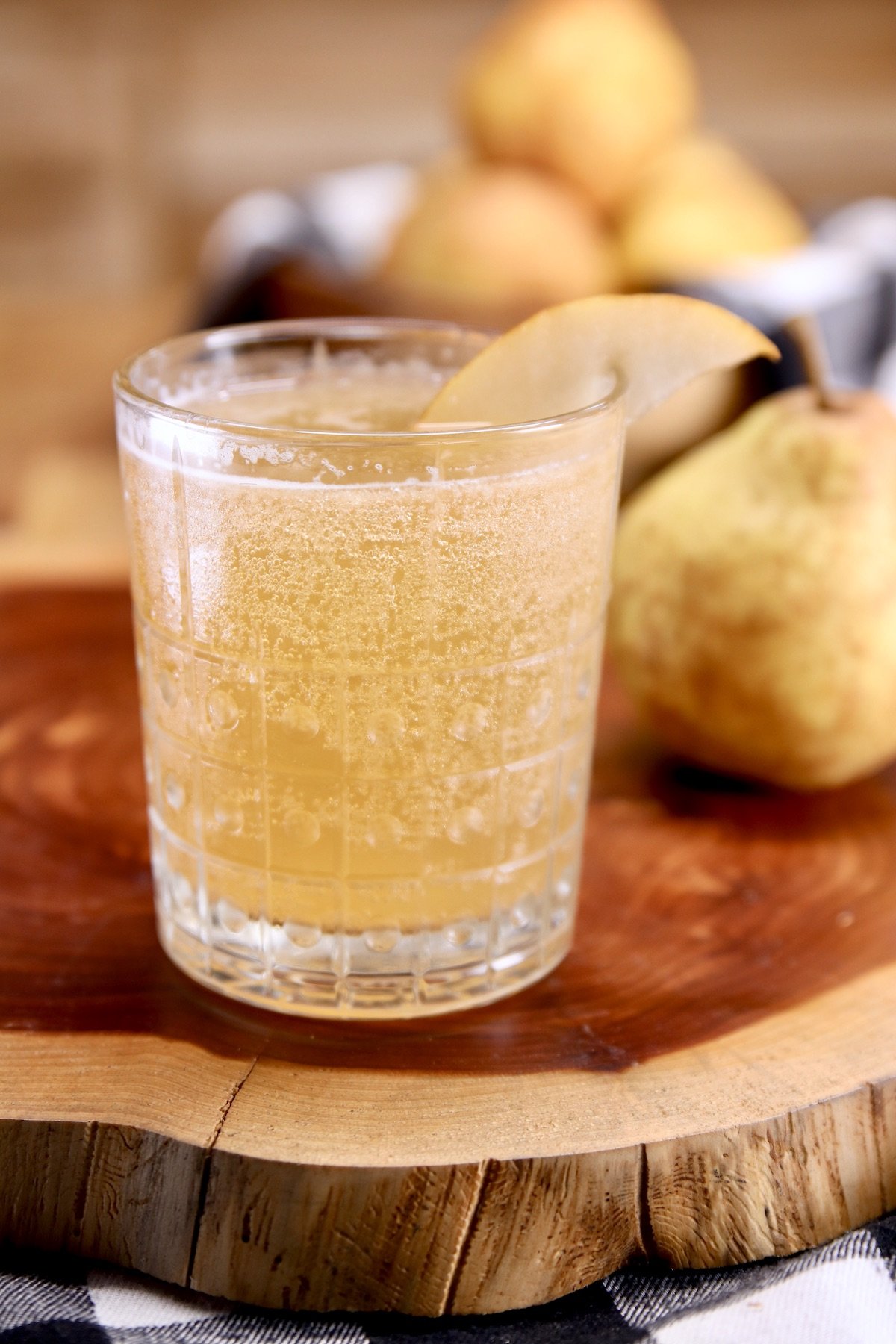 Pear Whiskey Smash cocktail on a wood board