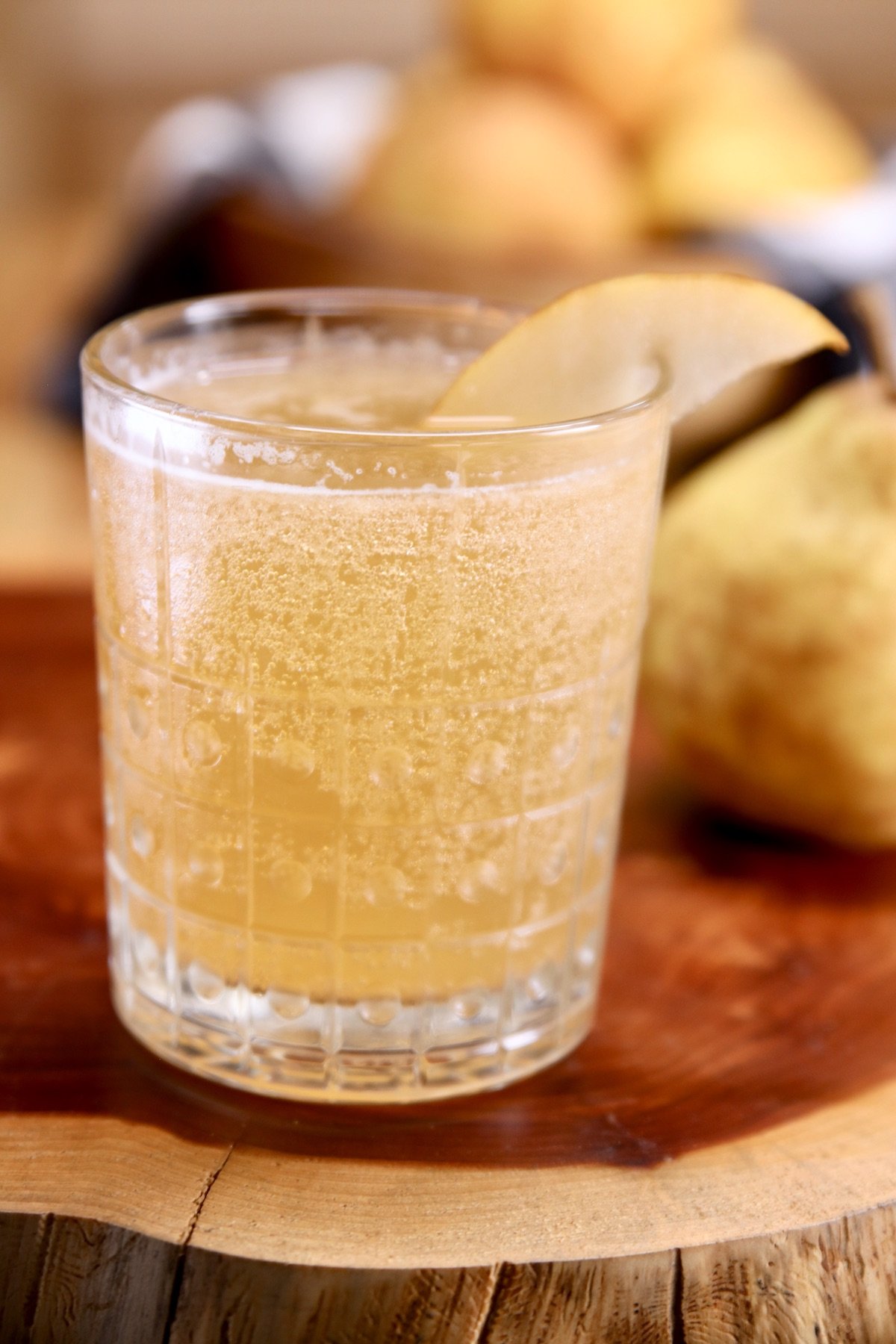 cocktail glass with pear whiskey smash - pear garnish