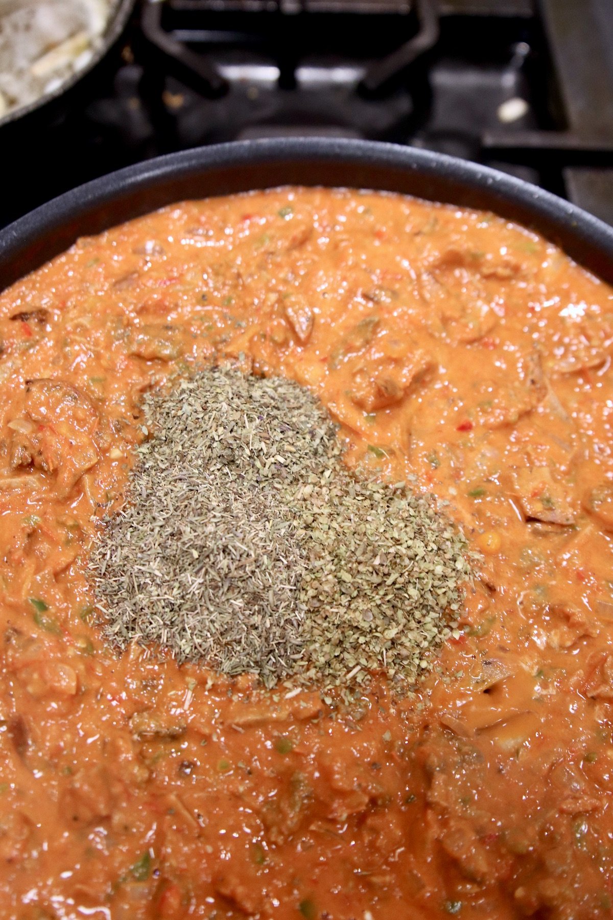 dried spices added to meat sauce in a skillet