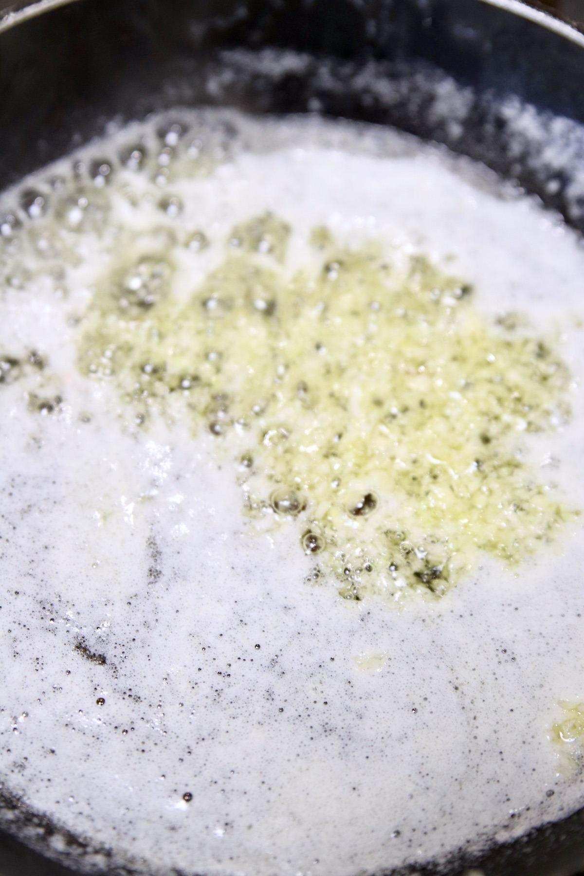 making garlic butter in a skillet