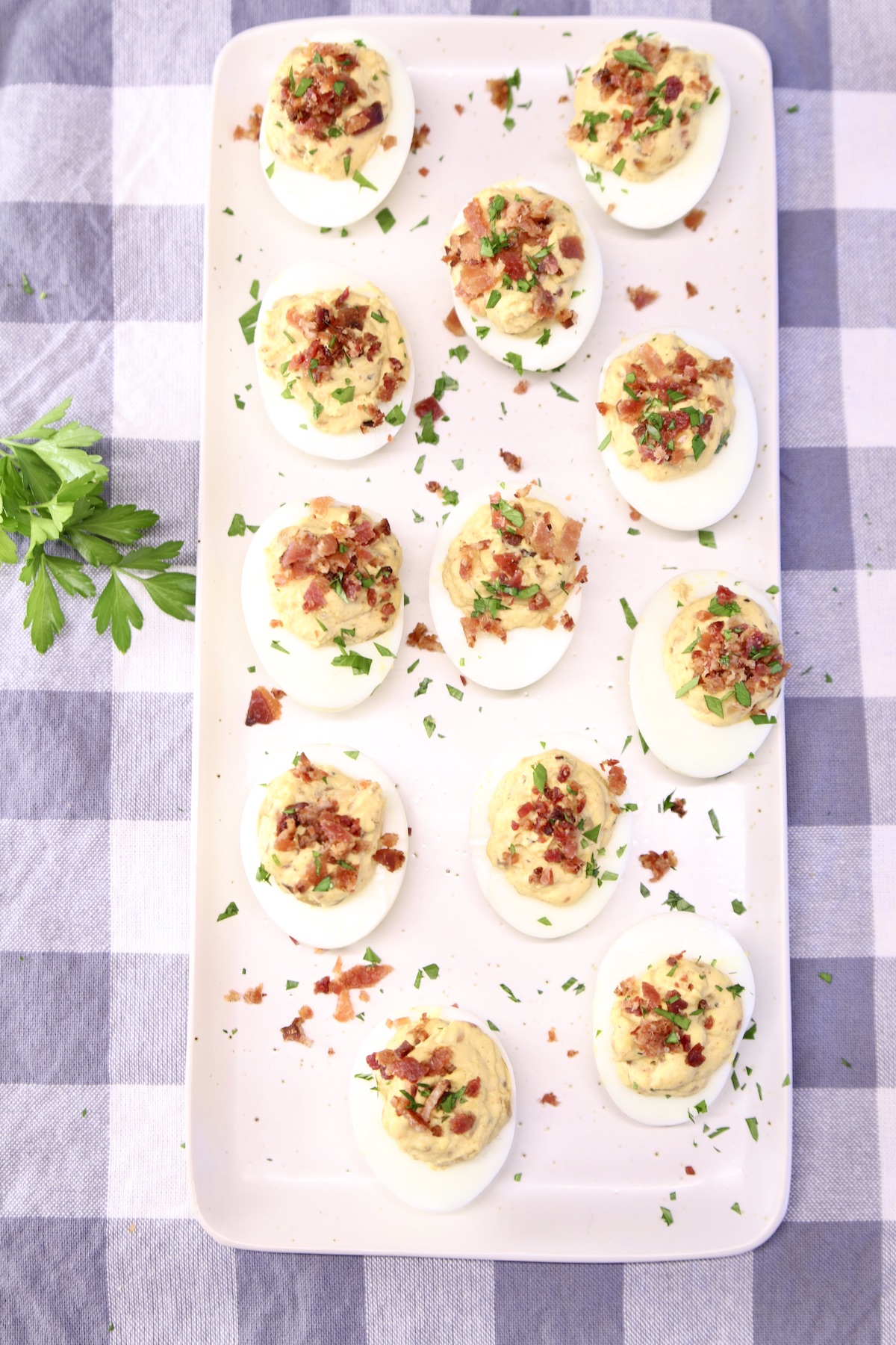 tray of deviled eggs on a check place mat