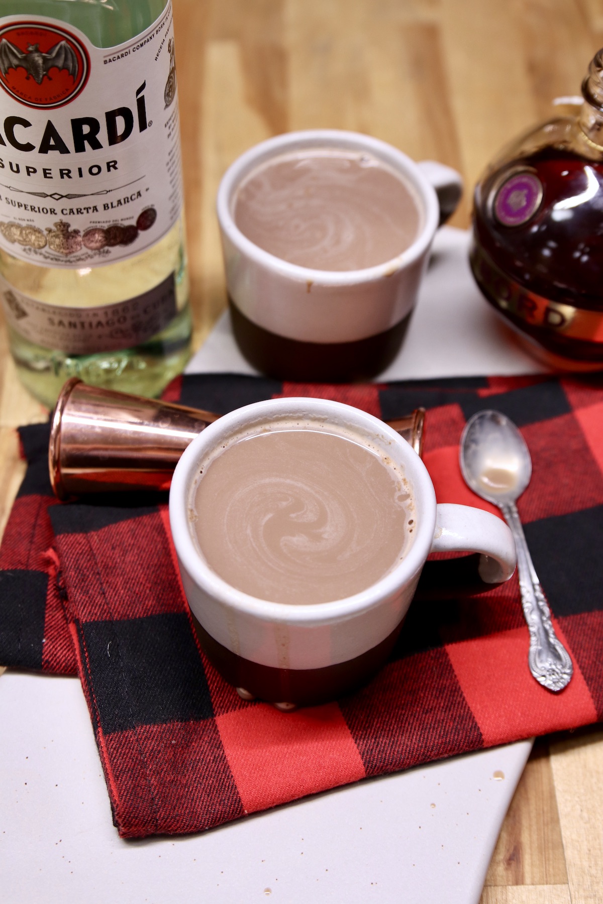 mugs of boozy hot chocolate - bottle of rum and chambord
