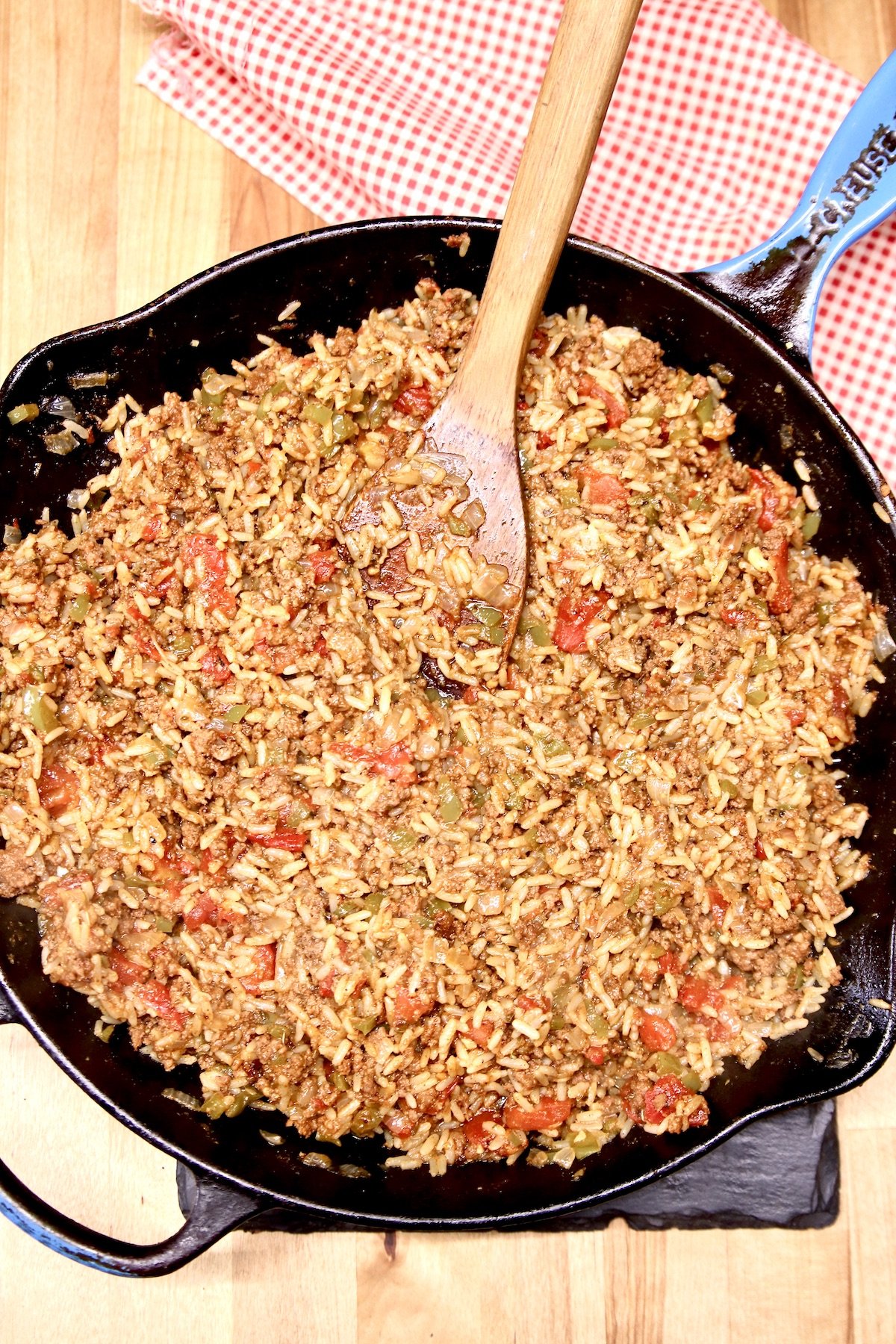 Spanish Rice in a skillet with wood spoon
