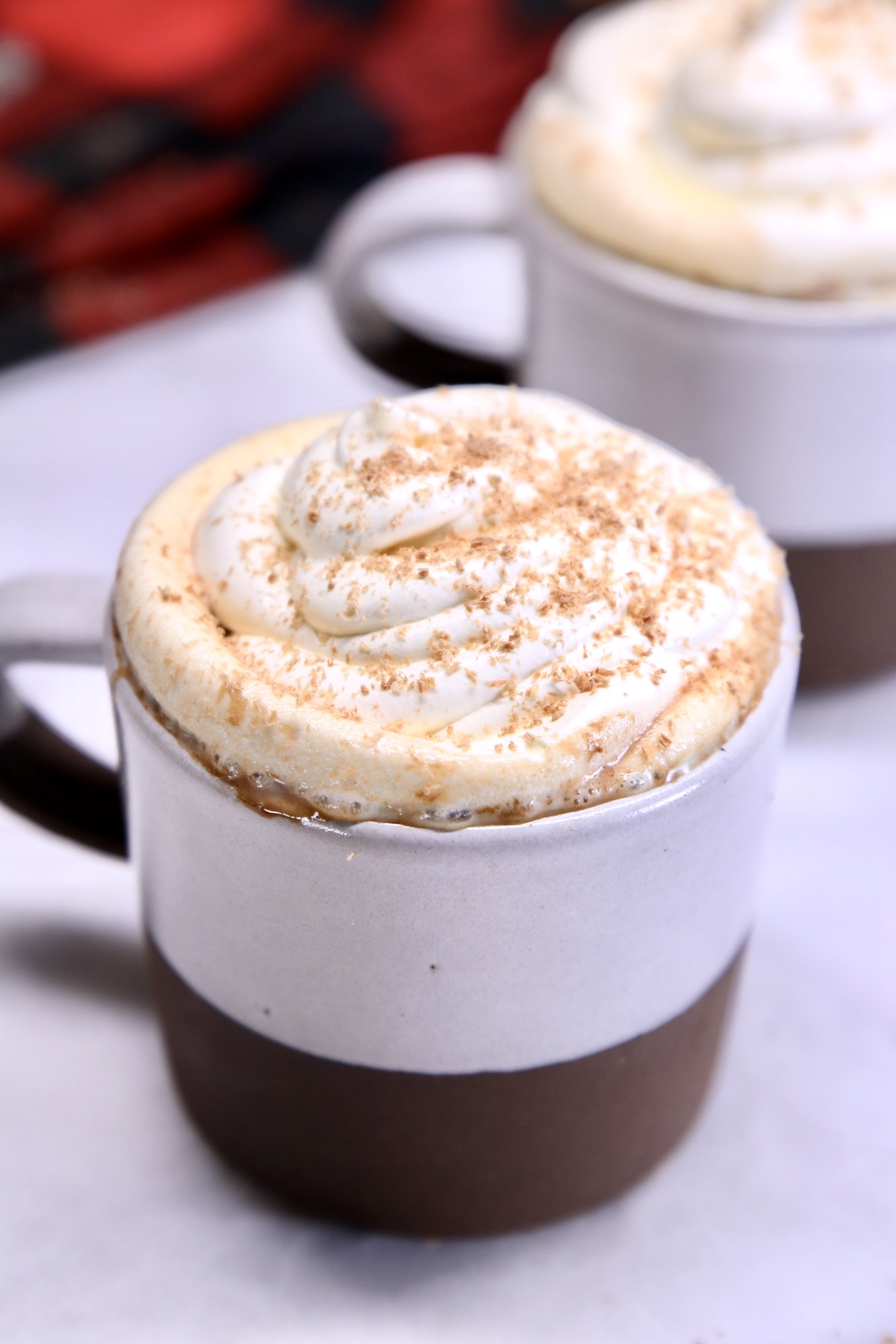 raspberry hot chocolate with whipped cream in 2 mugs