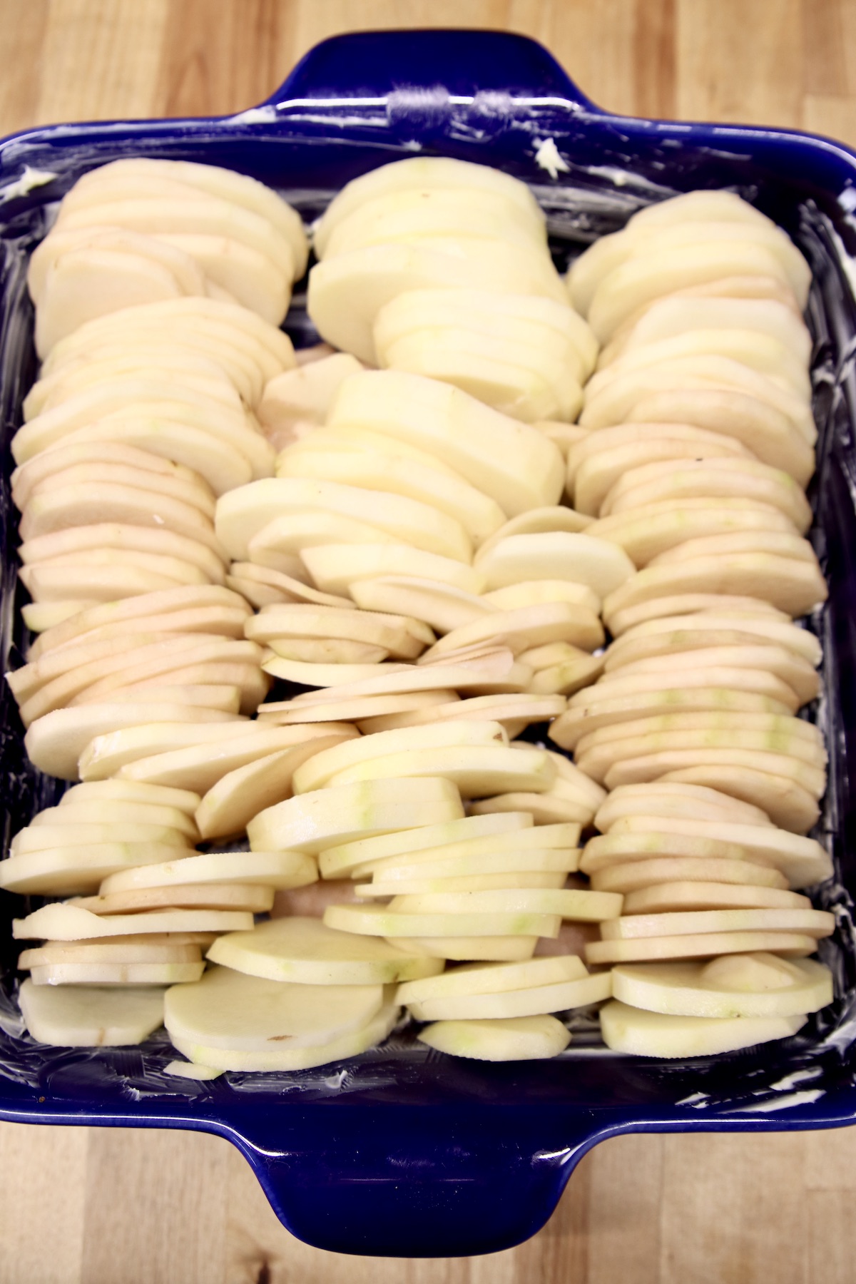 potato slices in a casserole dish