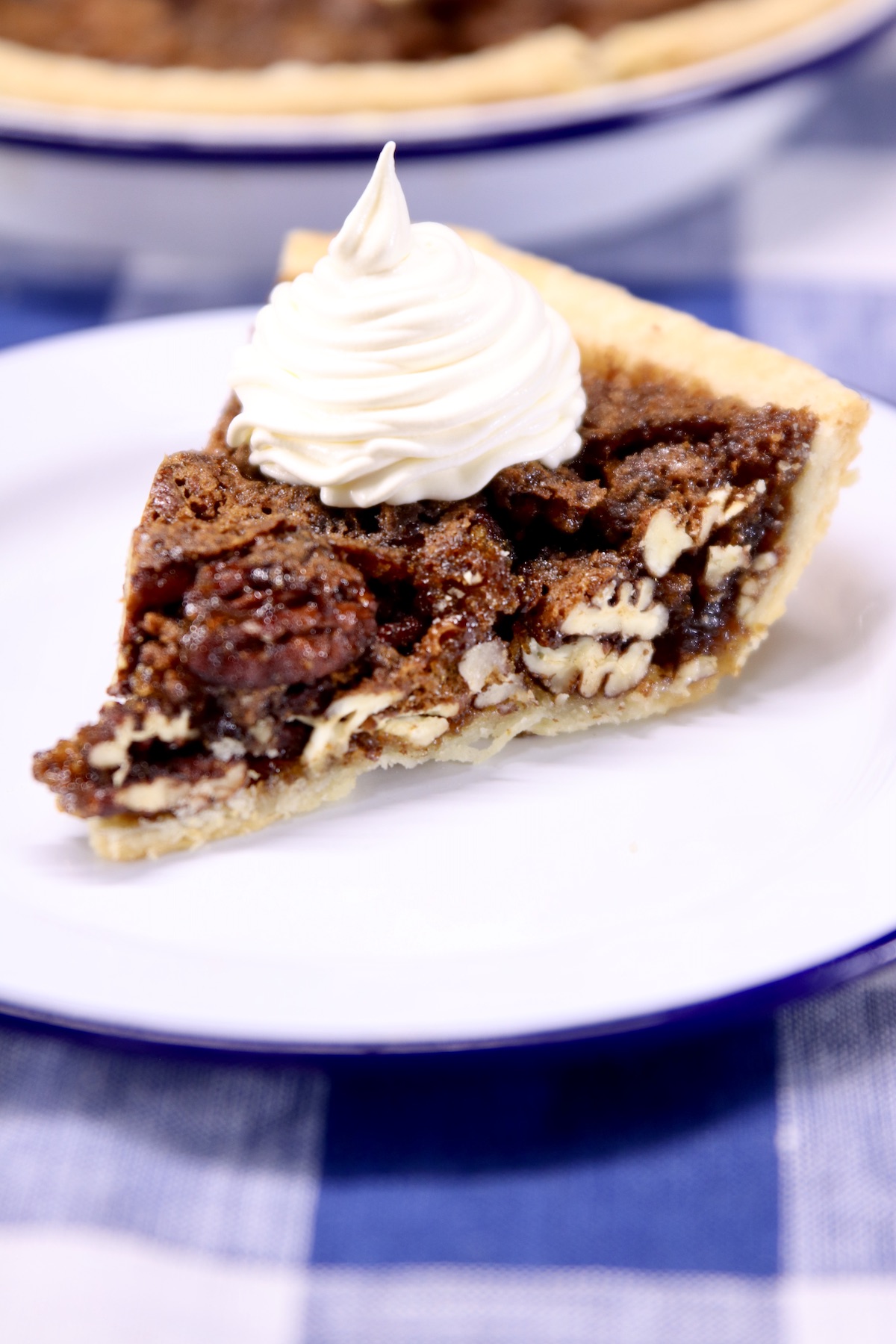 brown sugar pecan pie slice with whipped cream