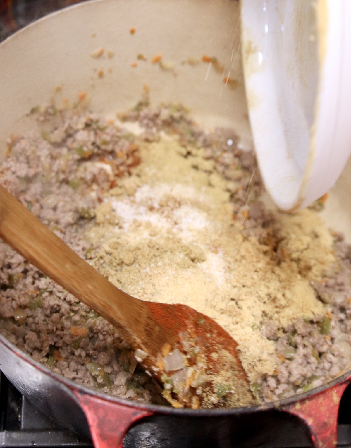 adding brown sugar and spices to dutch oven