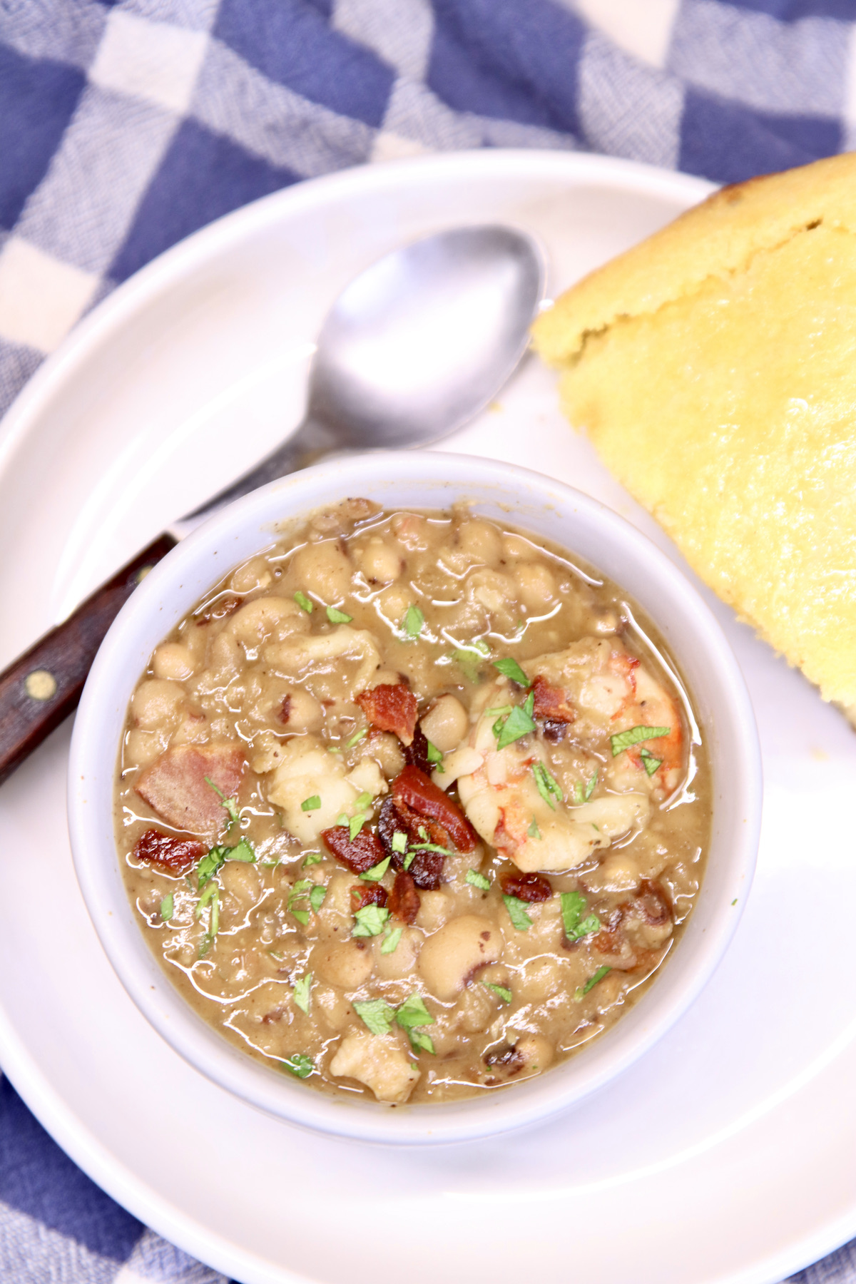 close up of bowl of black eyed peas with shrimp and bacon