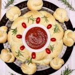 holiday bread wreath with rosemary and tomato garnish- marinara dipping sauce in center