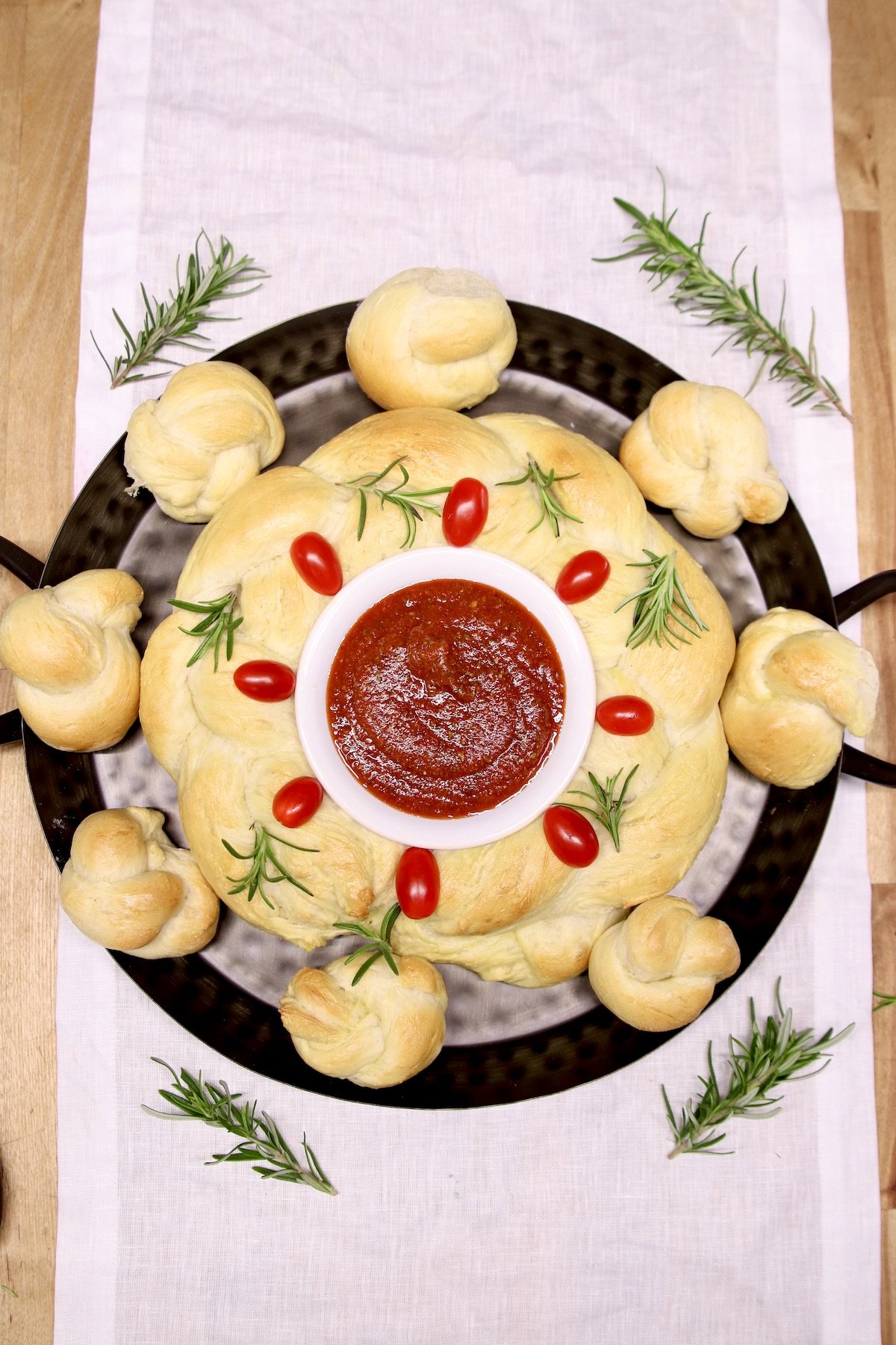 bread wreath with tomatoes and rosemary garnish