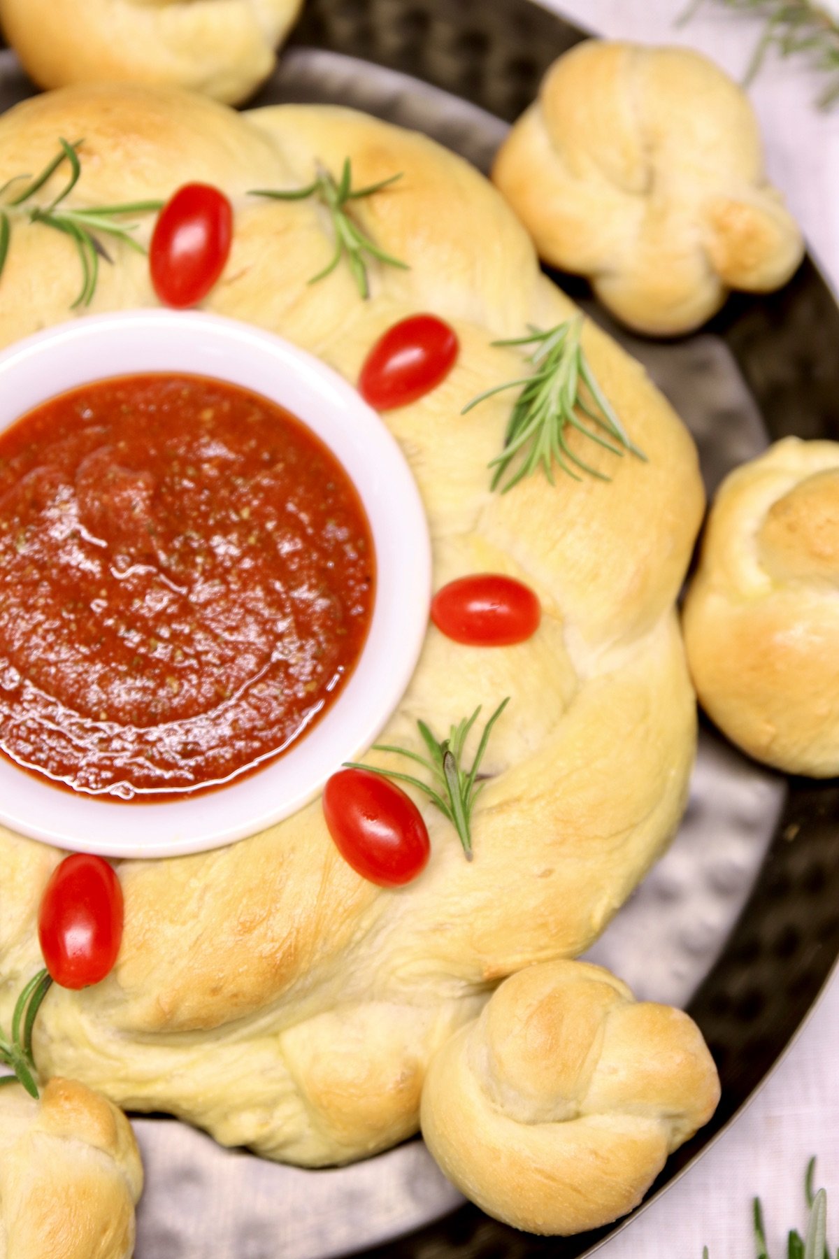 Holiday bread wreath with rosemary and tomatoes