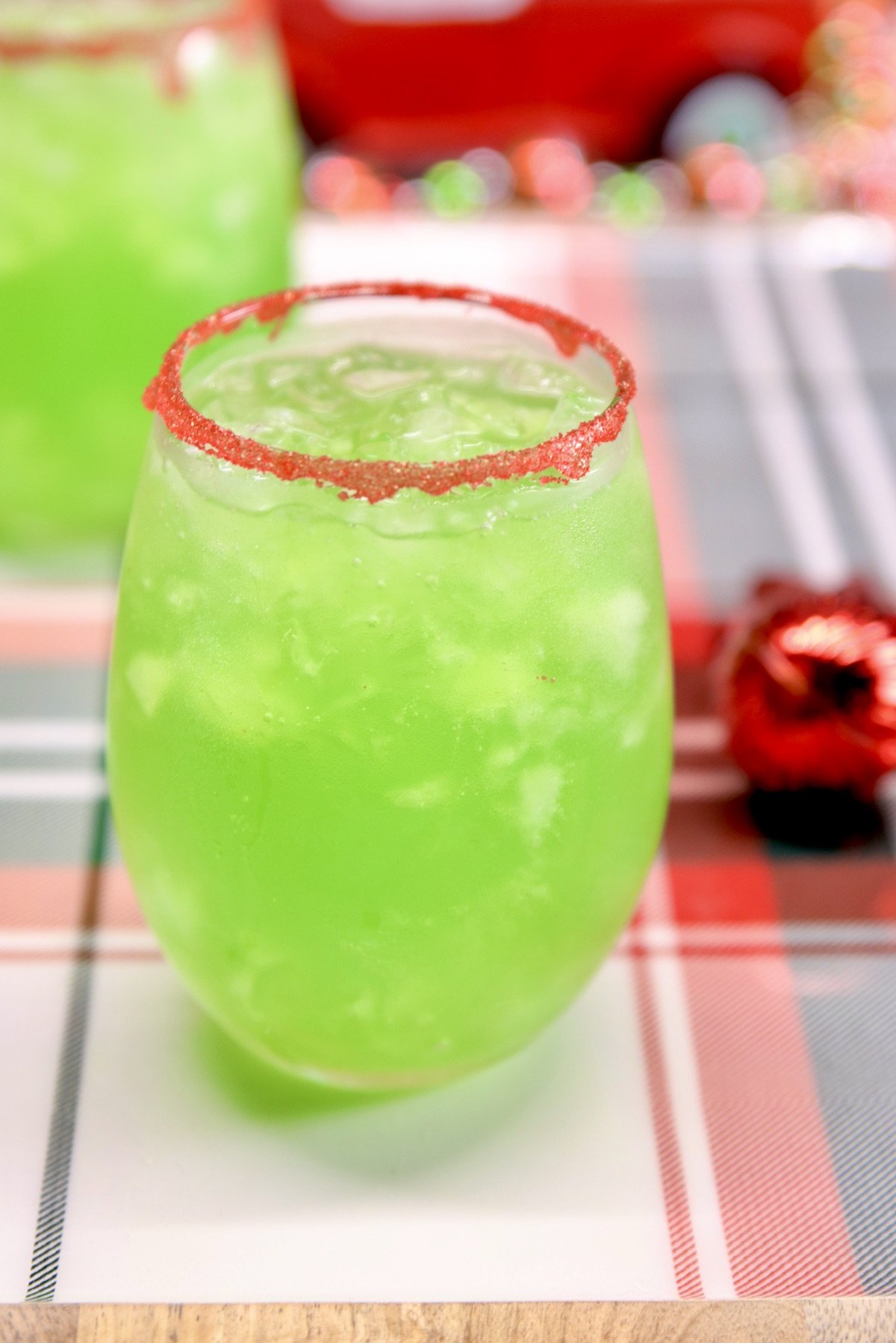 lemon-lime green punch in 2 stemless wine glasses - red sugar rim