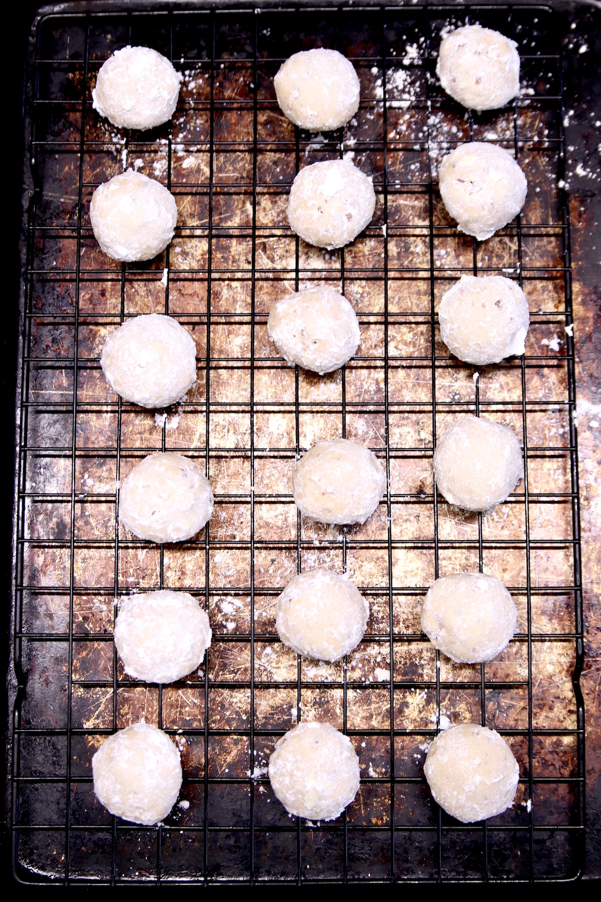 snowball cookies on a wire rack