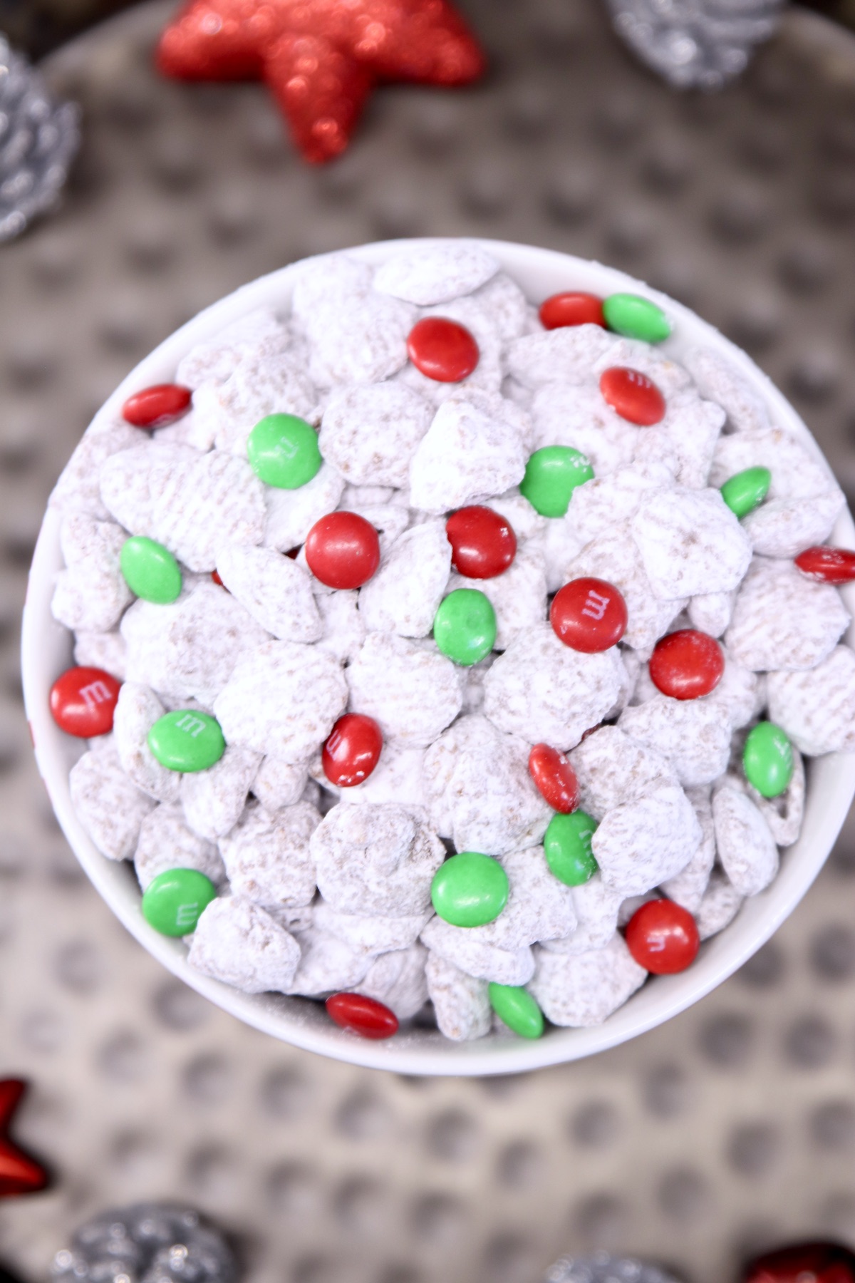overhead of bowl of muddy buddies with red and green m&ms 