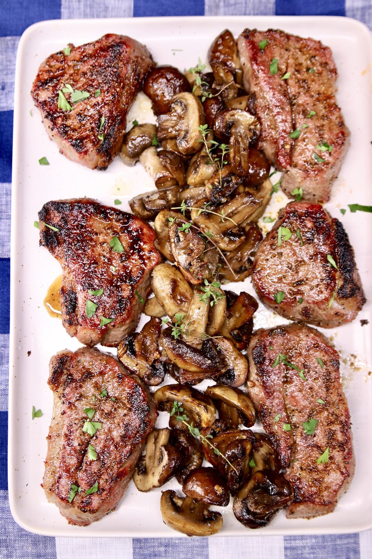 platter of grilled steaks with mushrooms