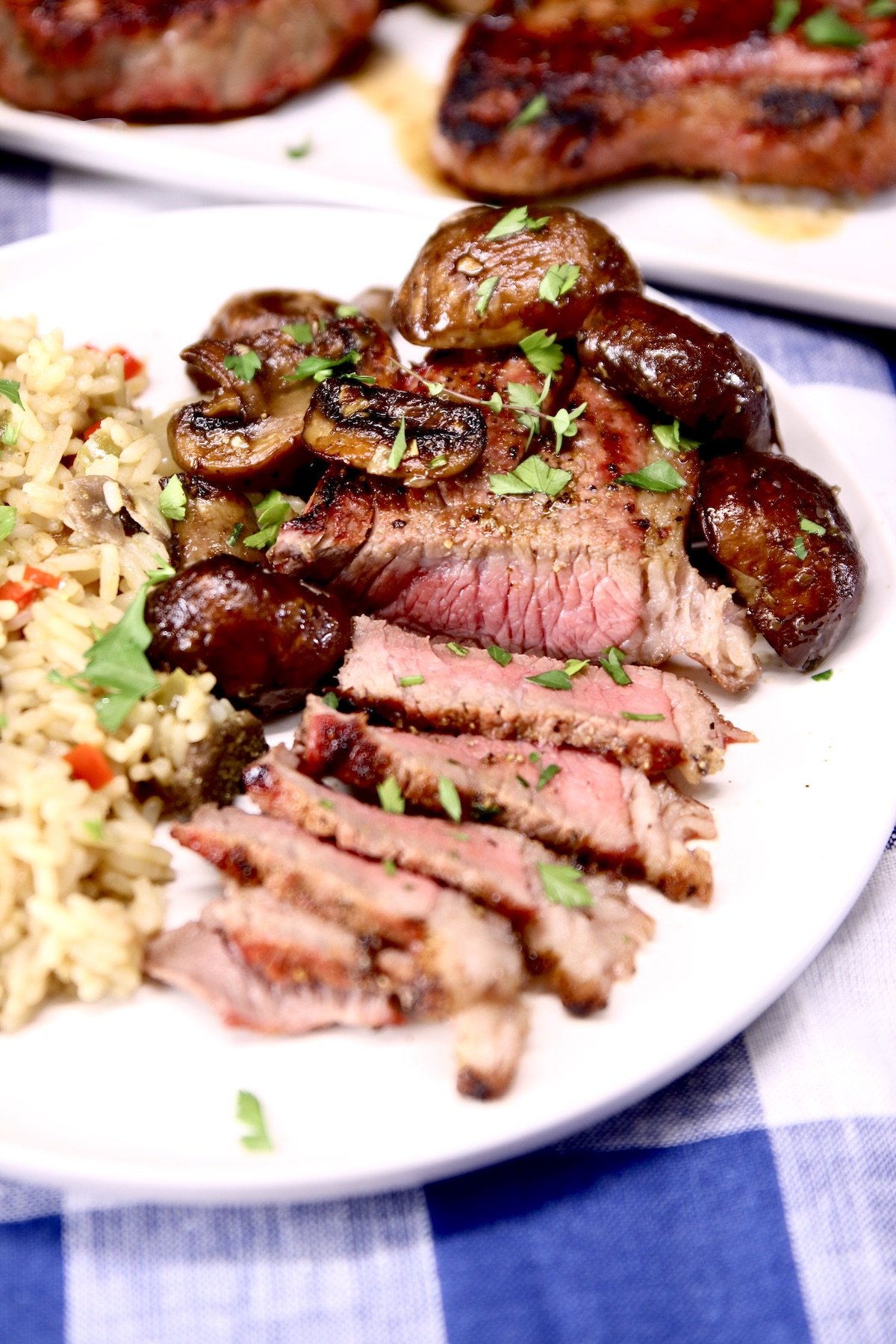 sliced steak with mushrooms on a plate