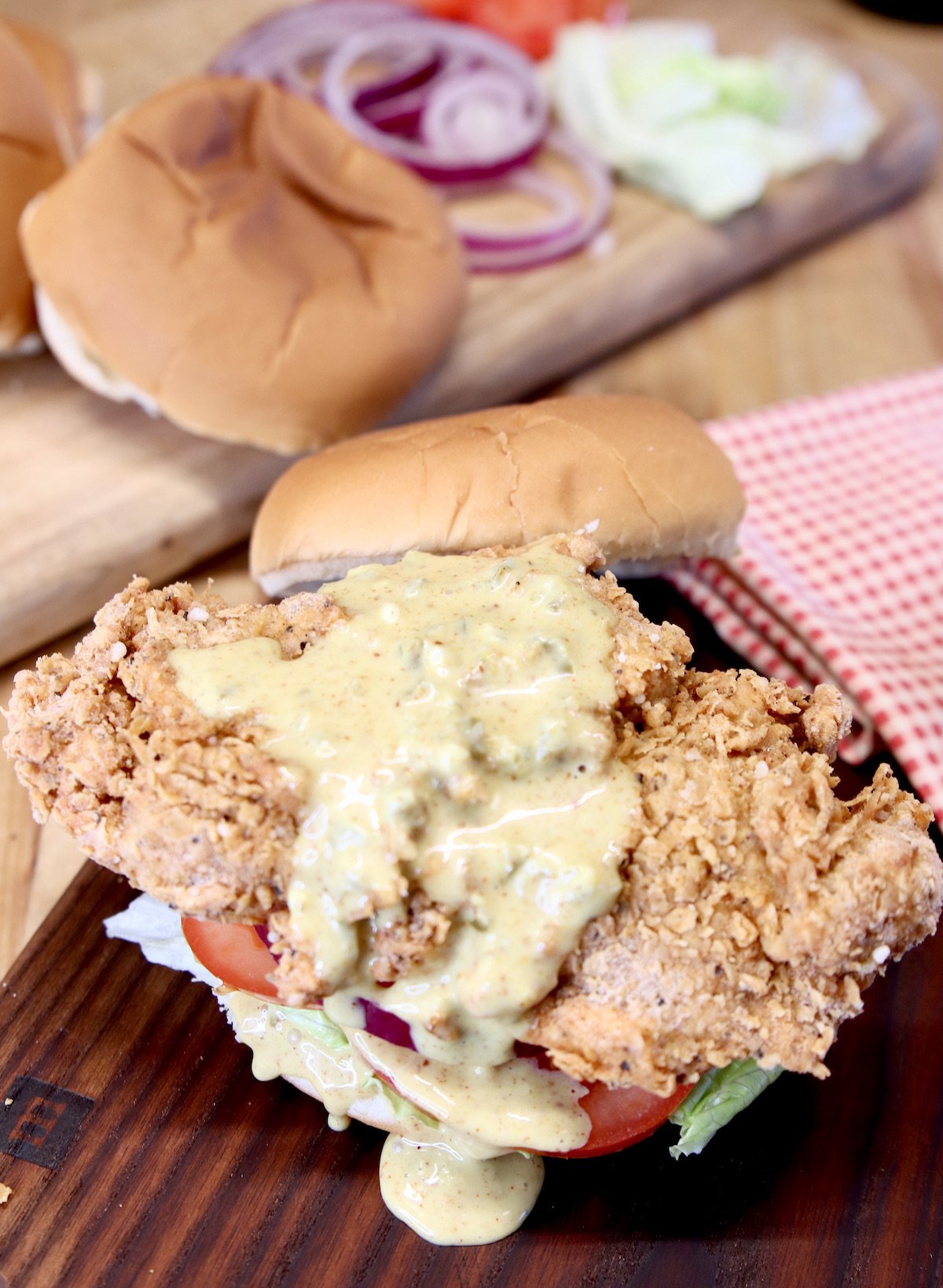 fried chicken sandwich with jalapeno honey mustard drizzled over