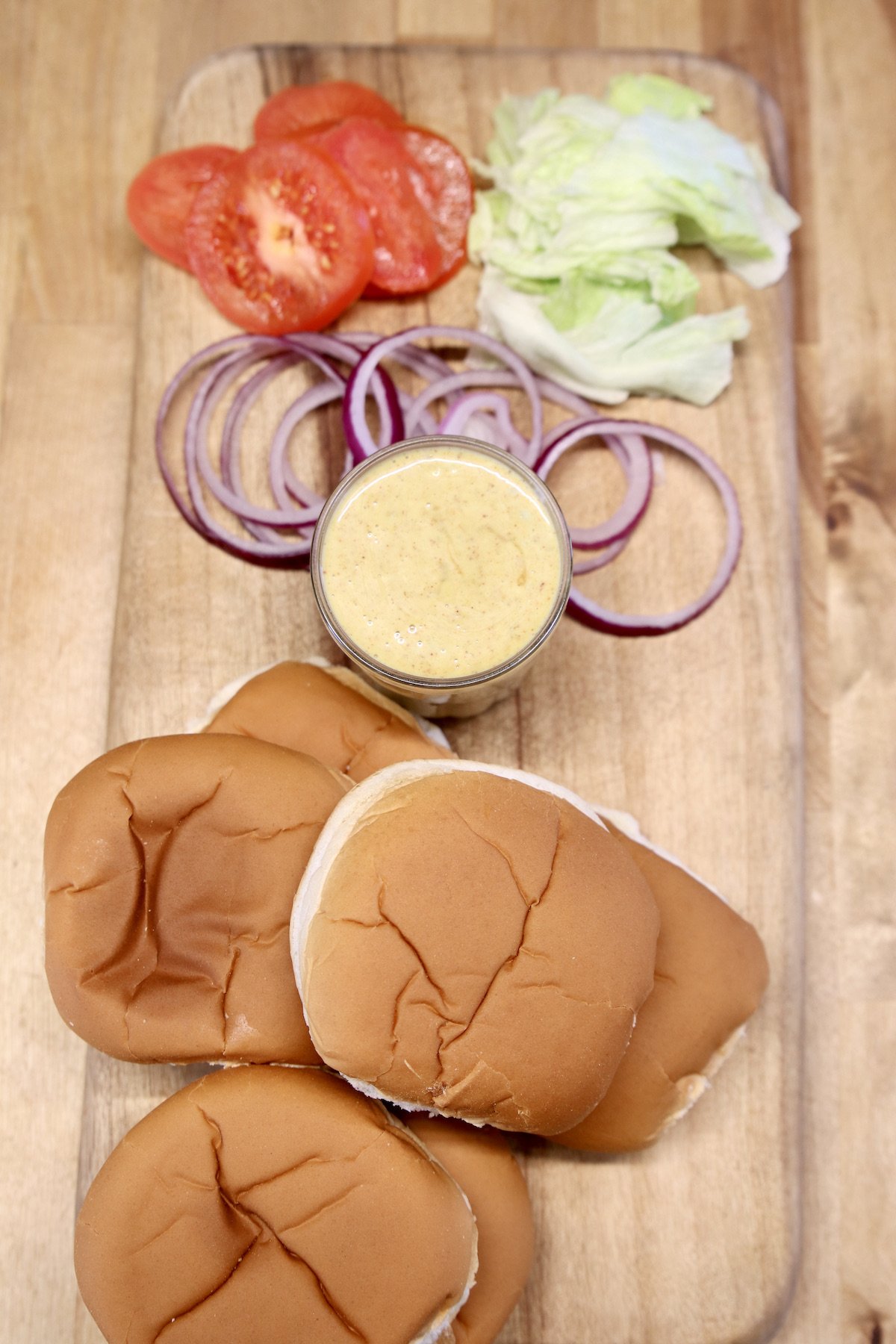 tomatoes, lettuce, red onion, mustard and buns