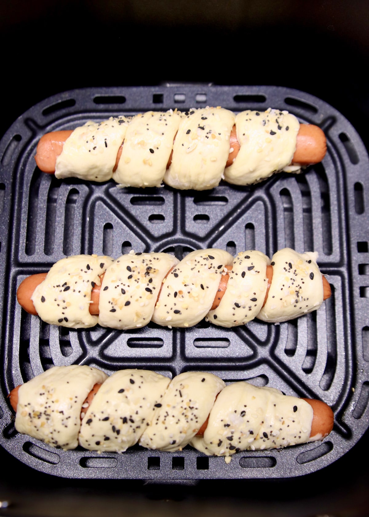 3 unbaked pretzel dogs in air fryer