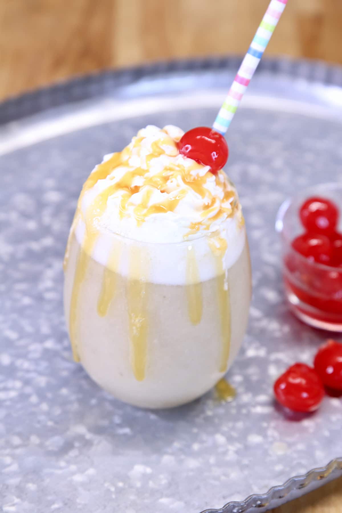 banana daiquiri with whipped cream, caramel sauce and a cherry on top.
