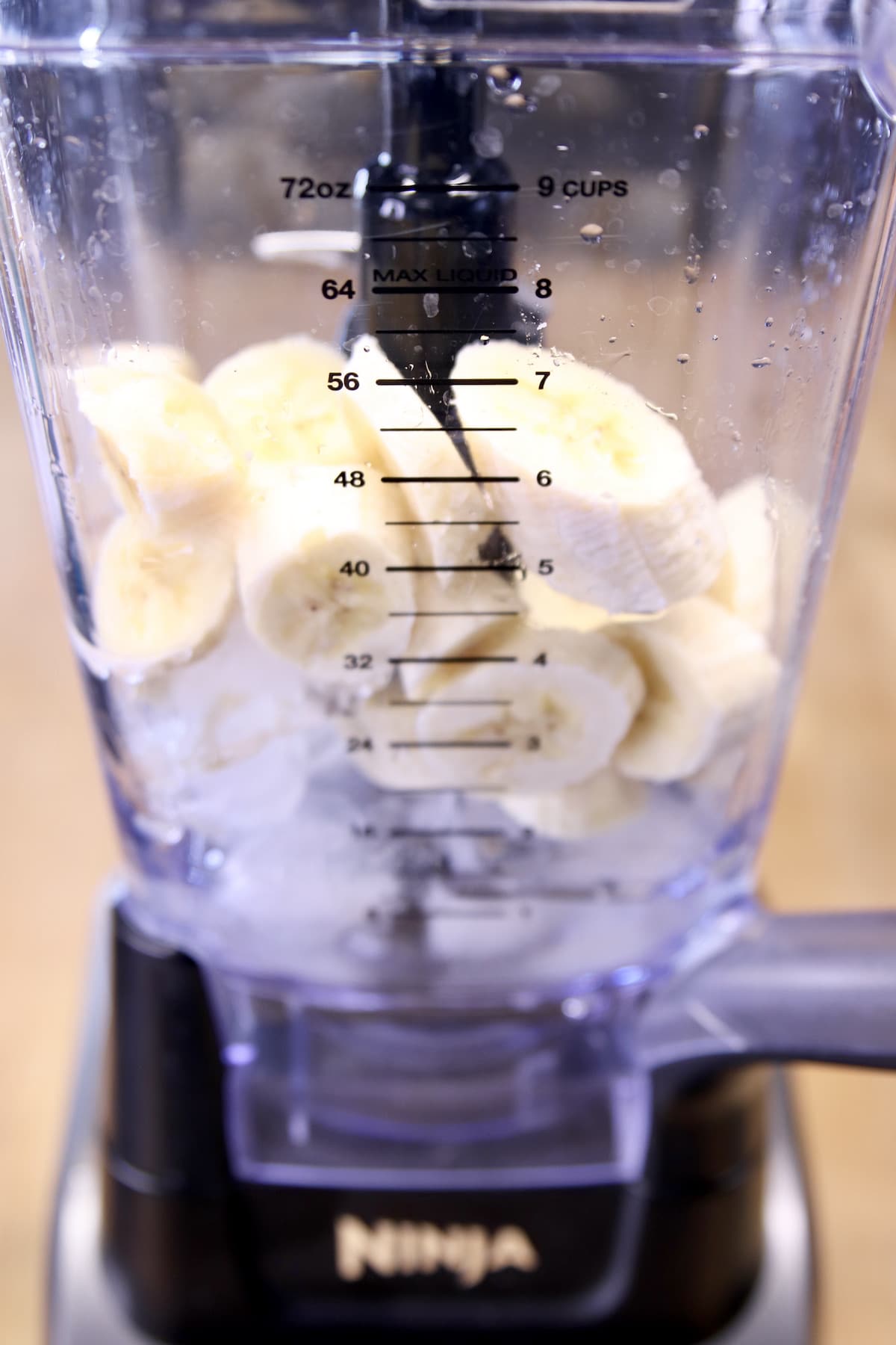 ice in a blender with sliced bananas.