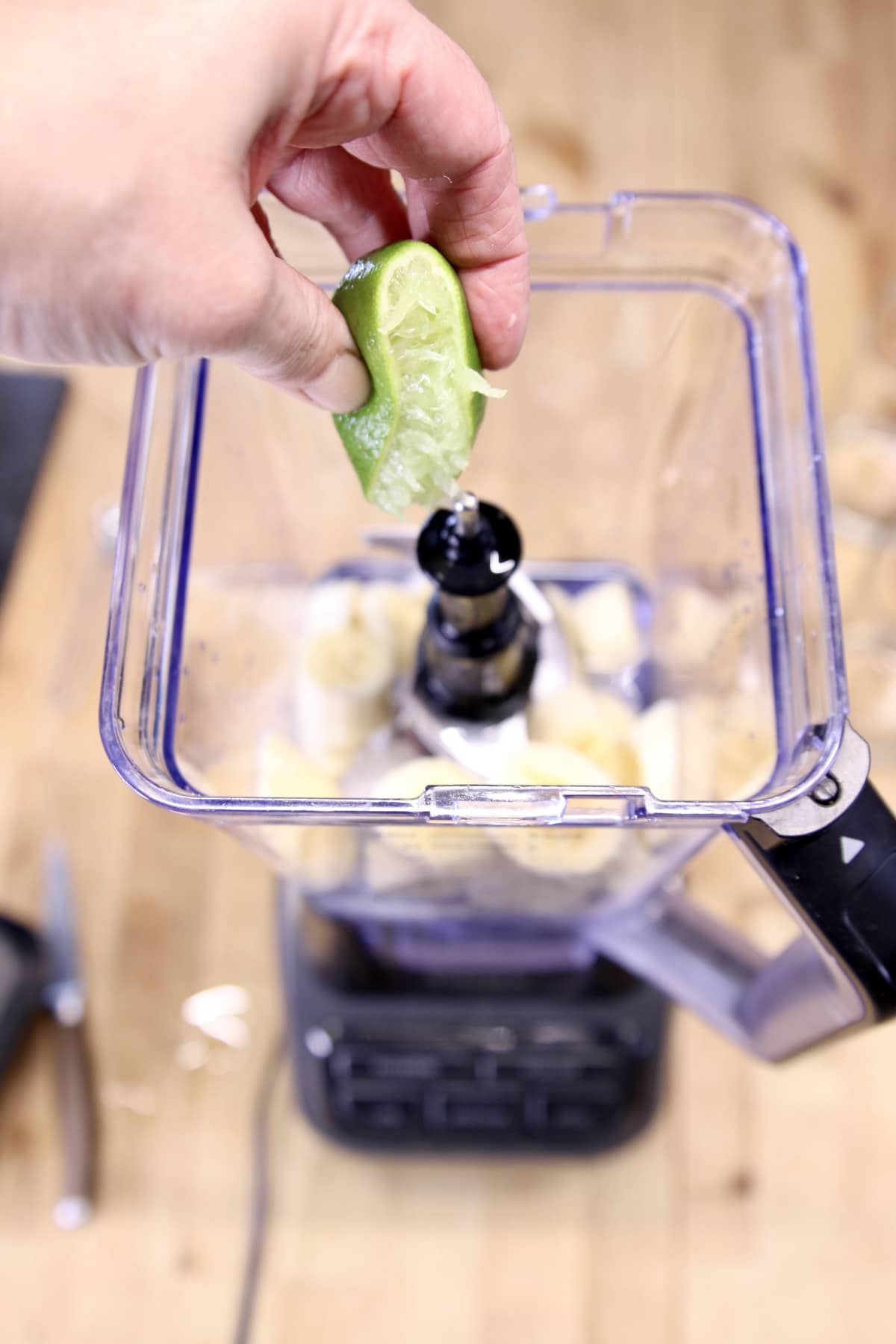 squeezing lime into blender.