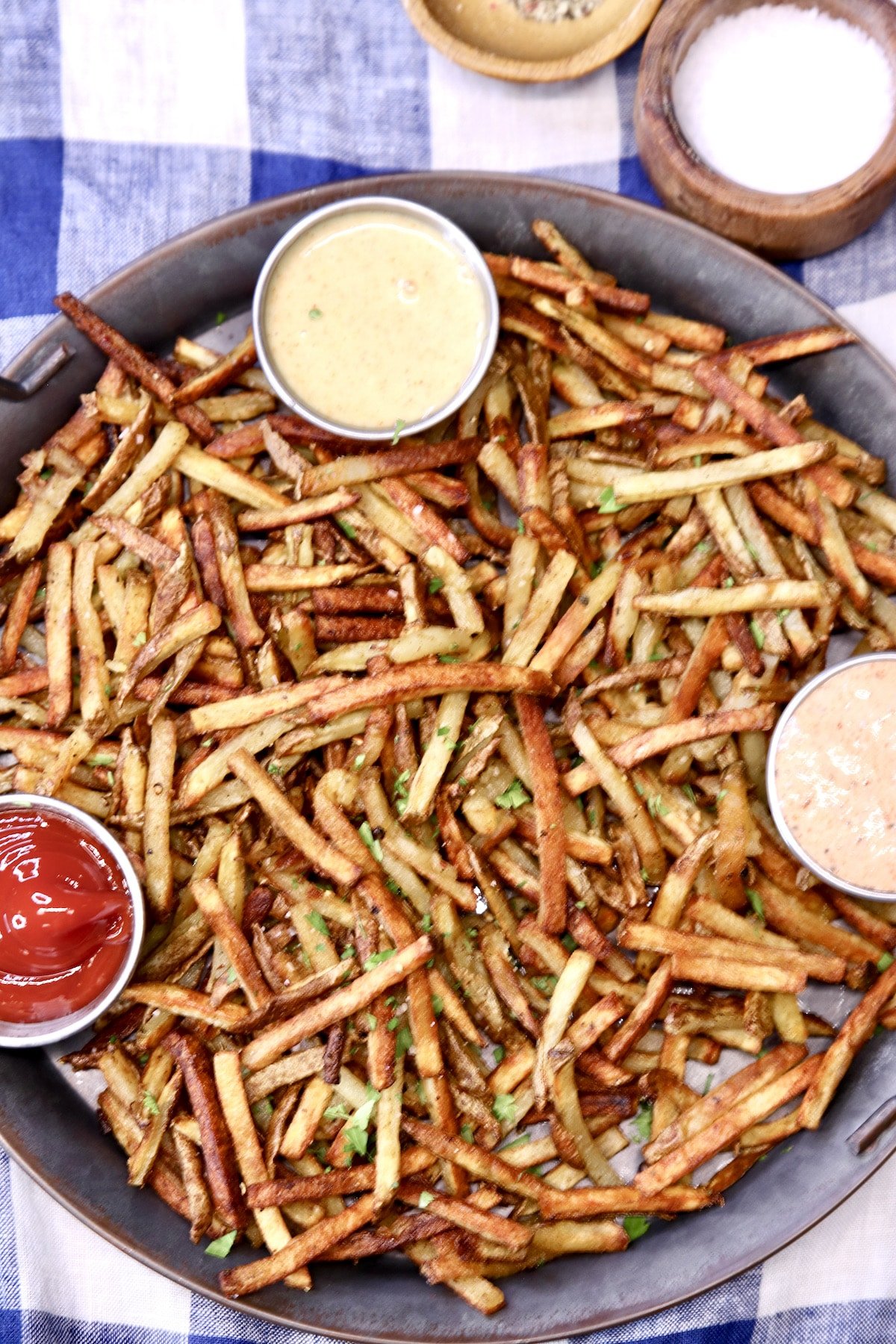 closeup of a tray of fries with dipping sauces