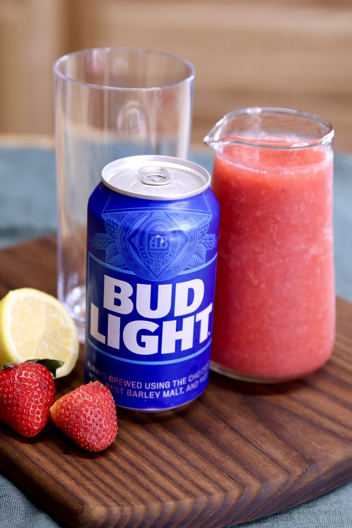 bud light beer can with jar of strawberry vodka cocktail mixture.