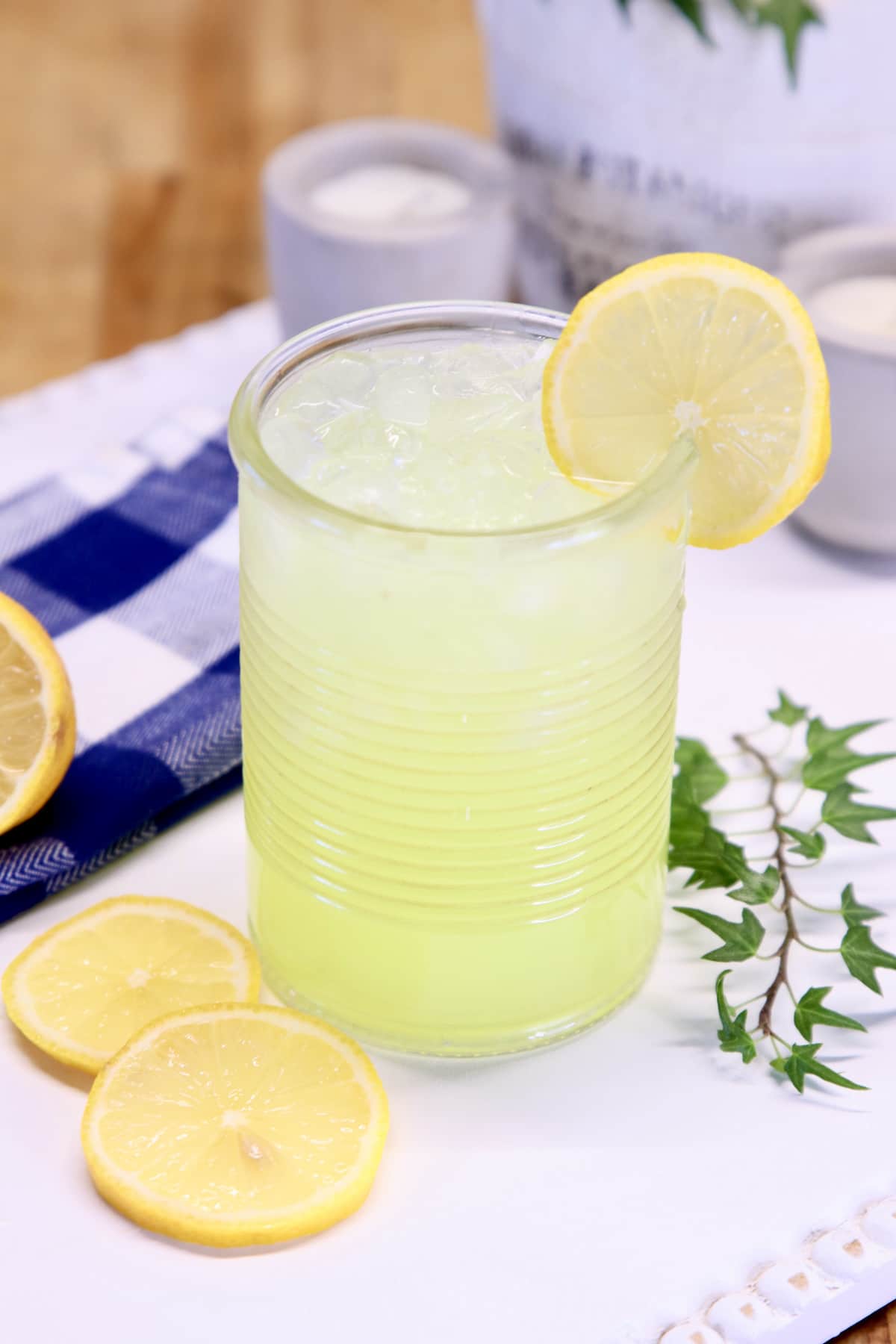lemonade in a glass with lemon garnish.