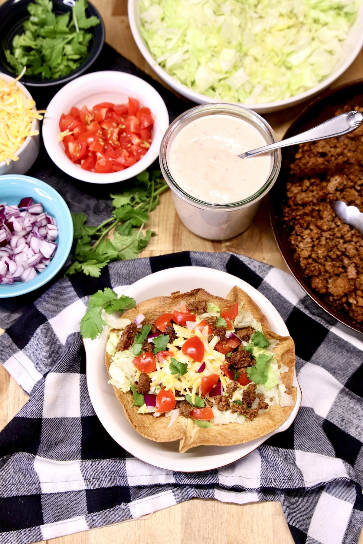 Taco Salad with ingredients around the bowl.