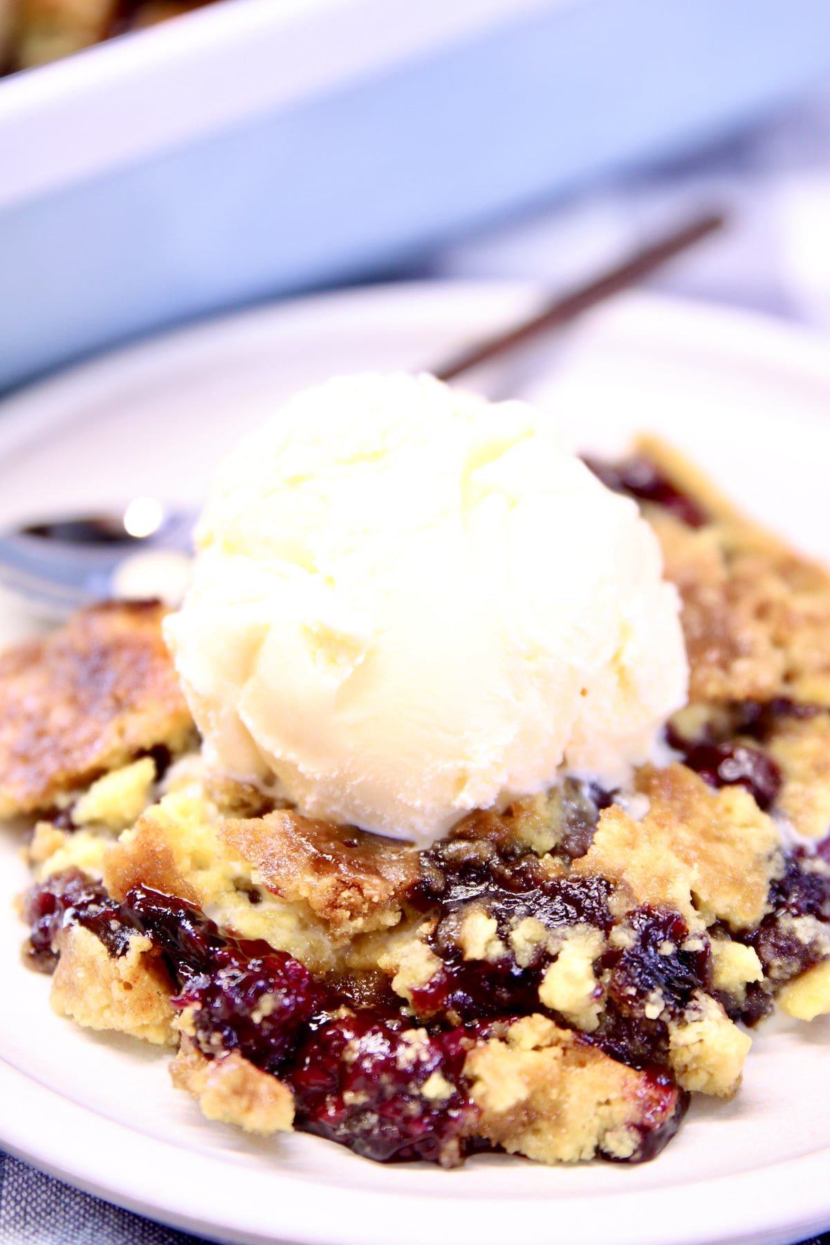 closeup of blackberry cobbler with scoop of ice cream.