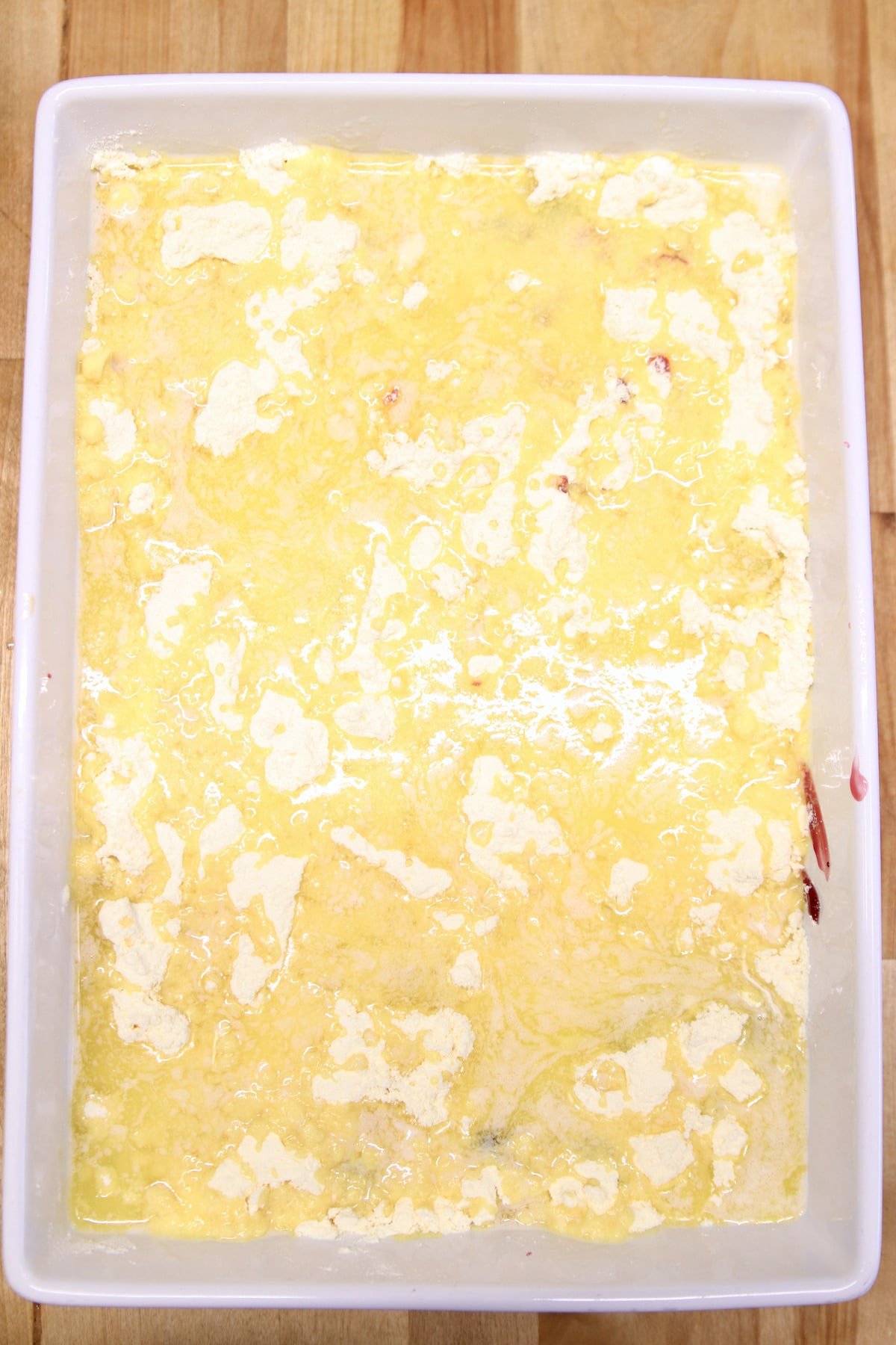cake mix drizzle with butter for dump cake in a cake pan.