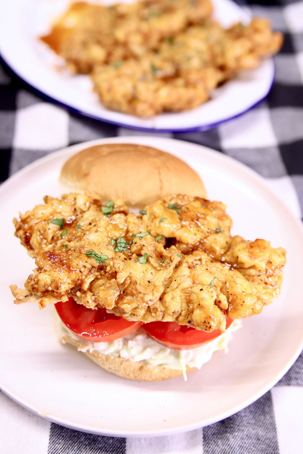 Chicken Tender Sandwich with slaw and tomatoes.