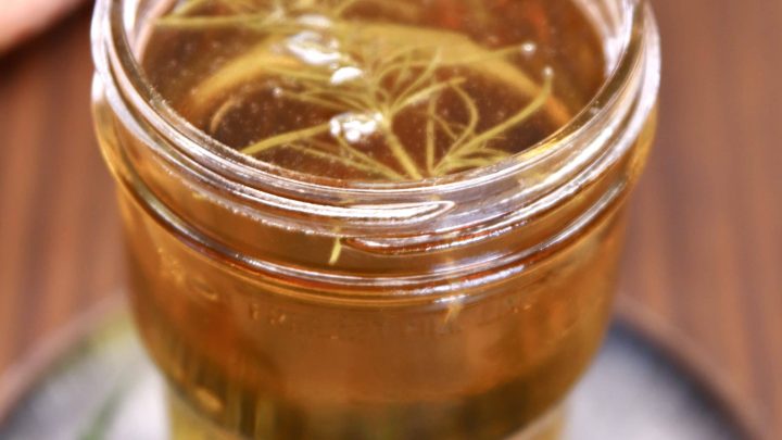 jar of smoked simple syrup with rosemary.