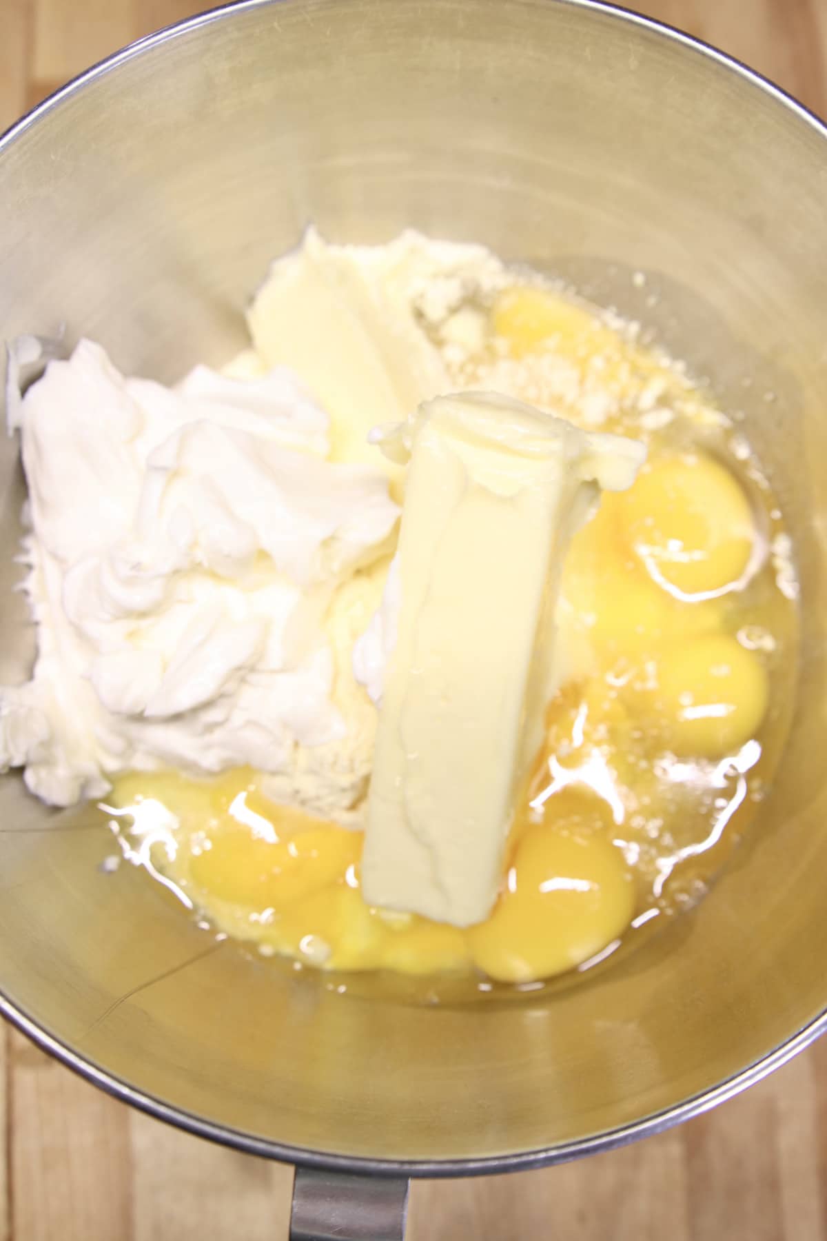 bowl of cake mix, butter, eggs, sour cream.