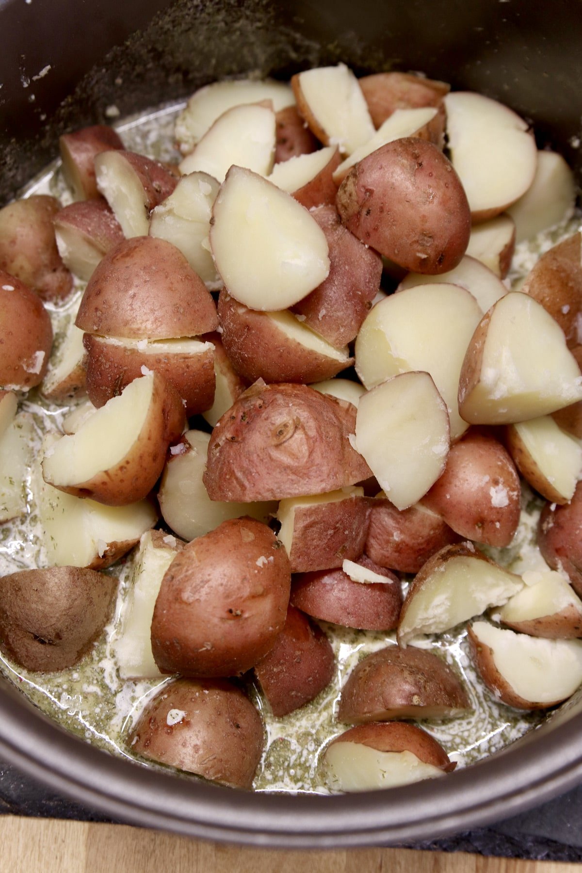 Cooked red potatoes in garlic butter.
