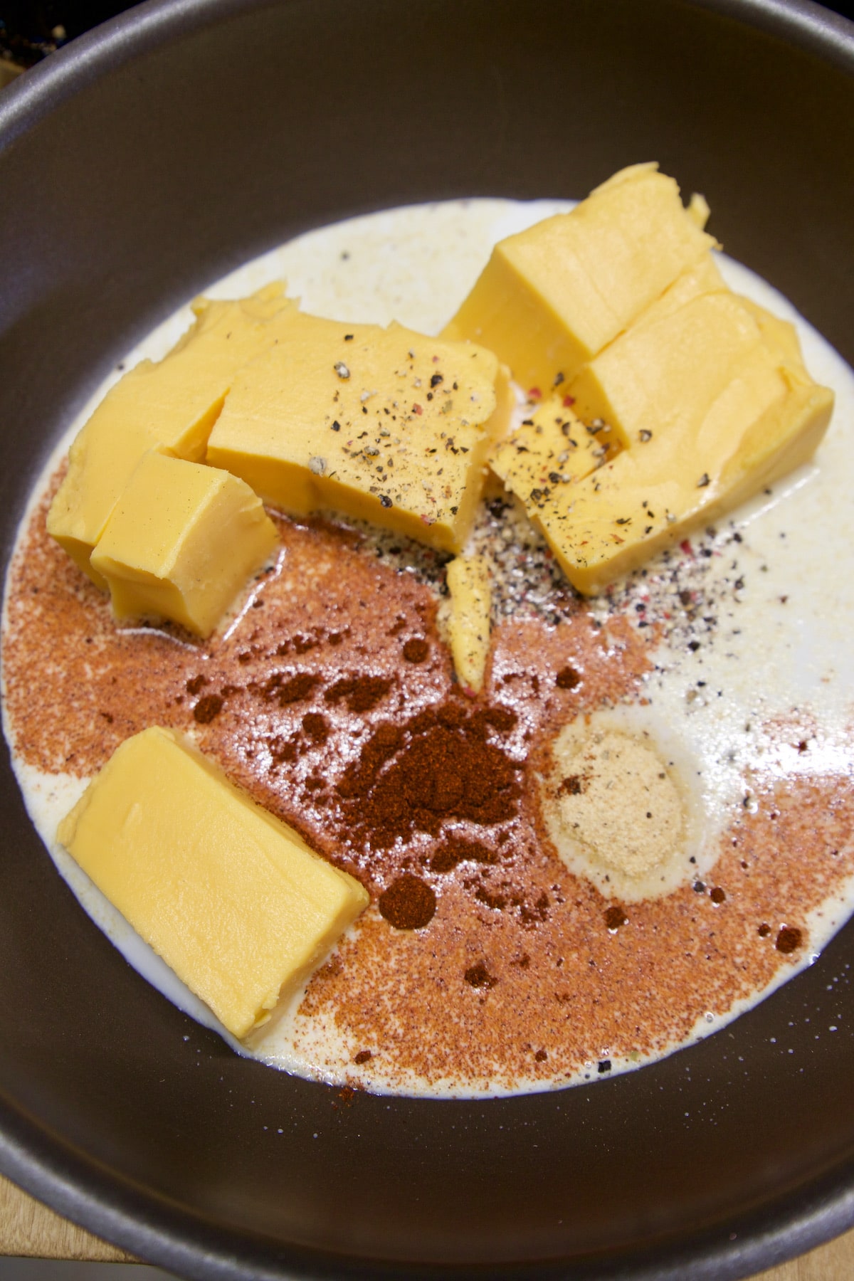 Making cheese sauce in a pan with velveeta.