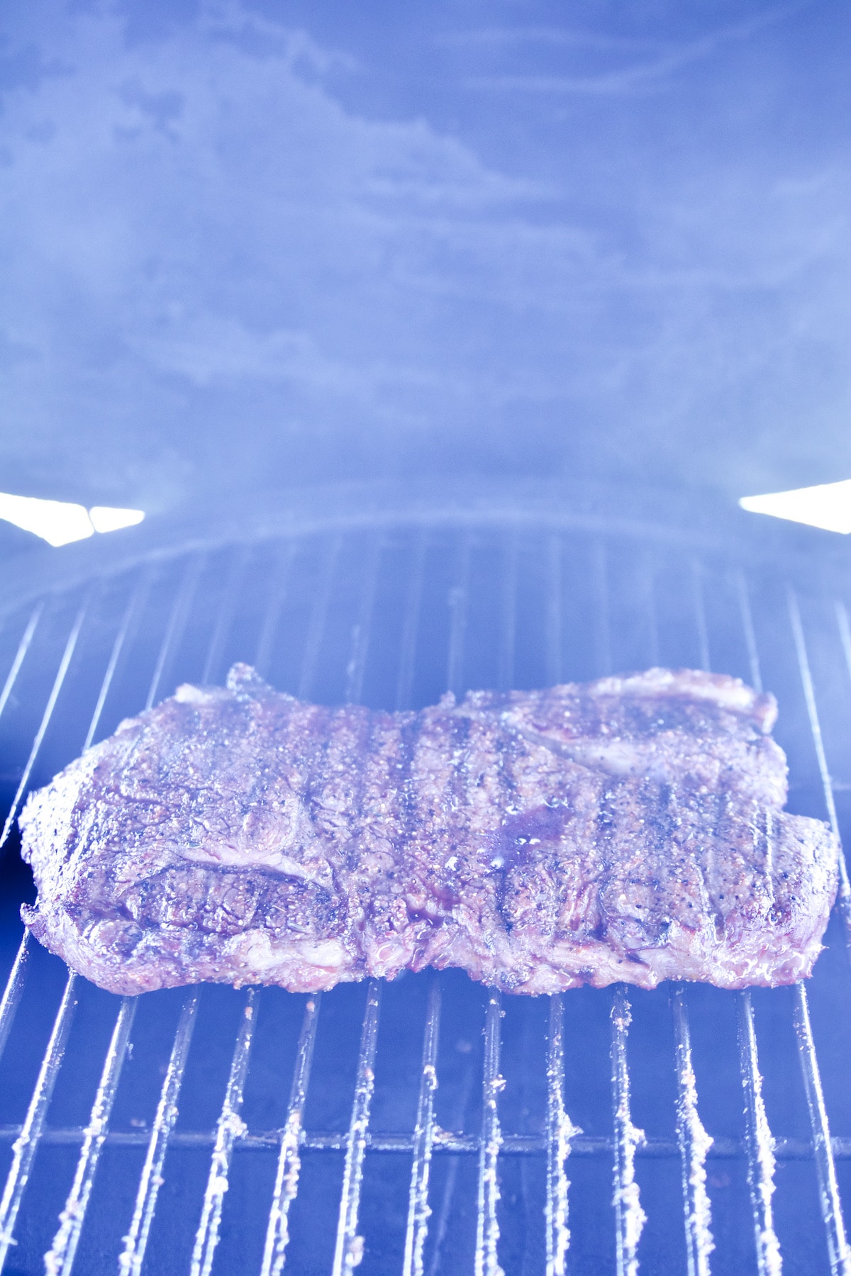 Sirloin steak on a grill.