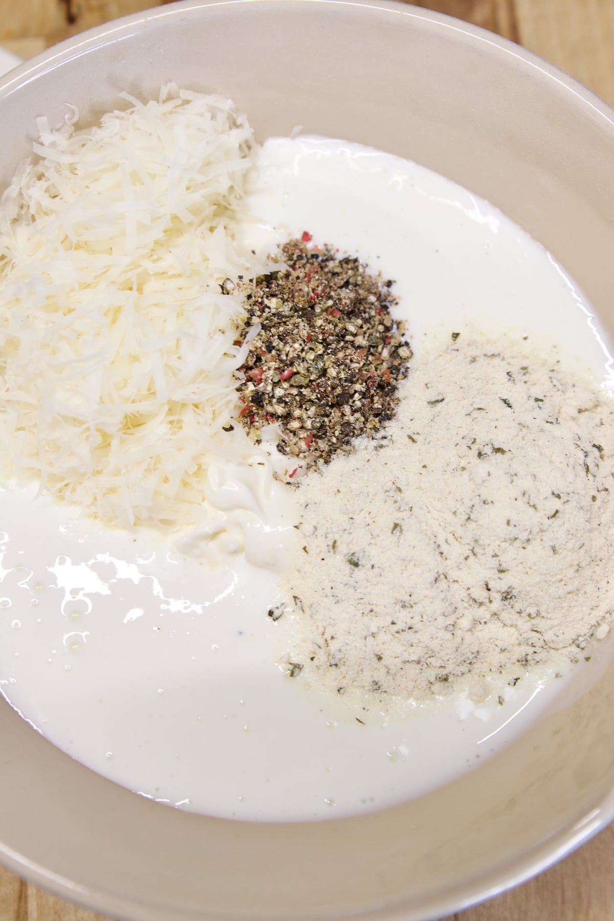 Bowl of mayo, buttermilk, parmesan, ranch mix, pepper.