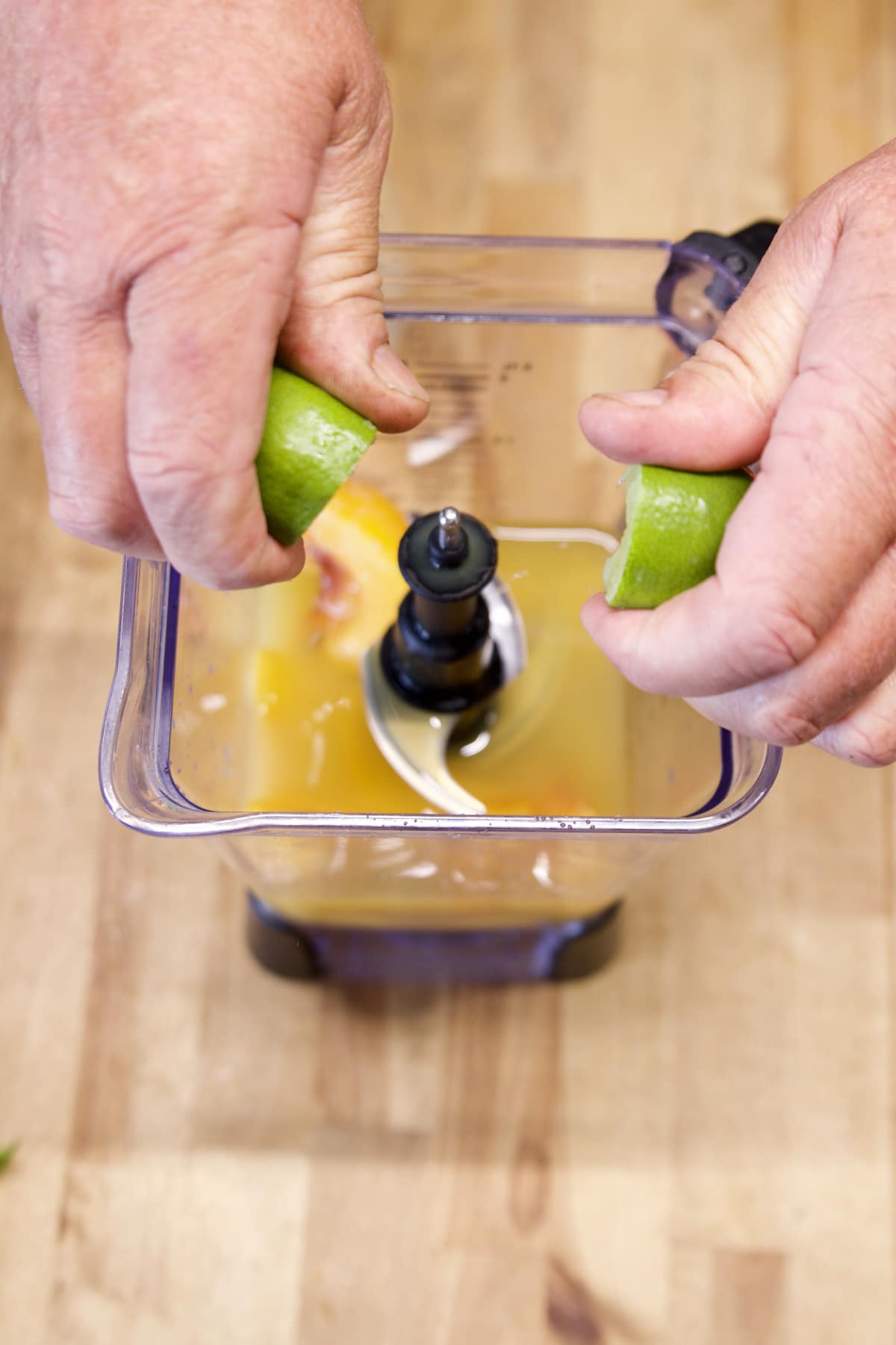 Squeezing lime juice into blender.