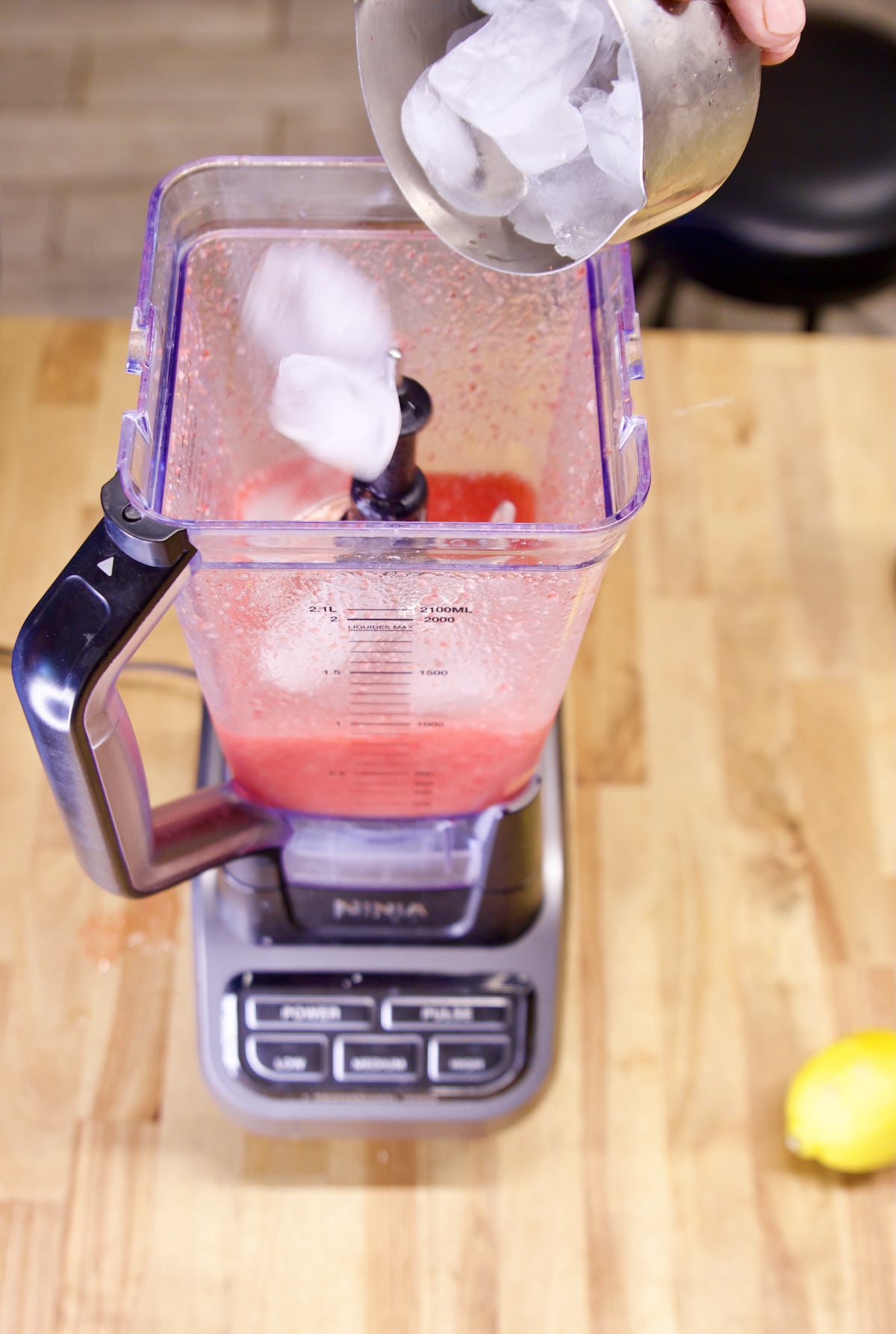 Adding ice to blender for frozen margaritas.