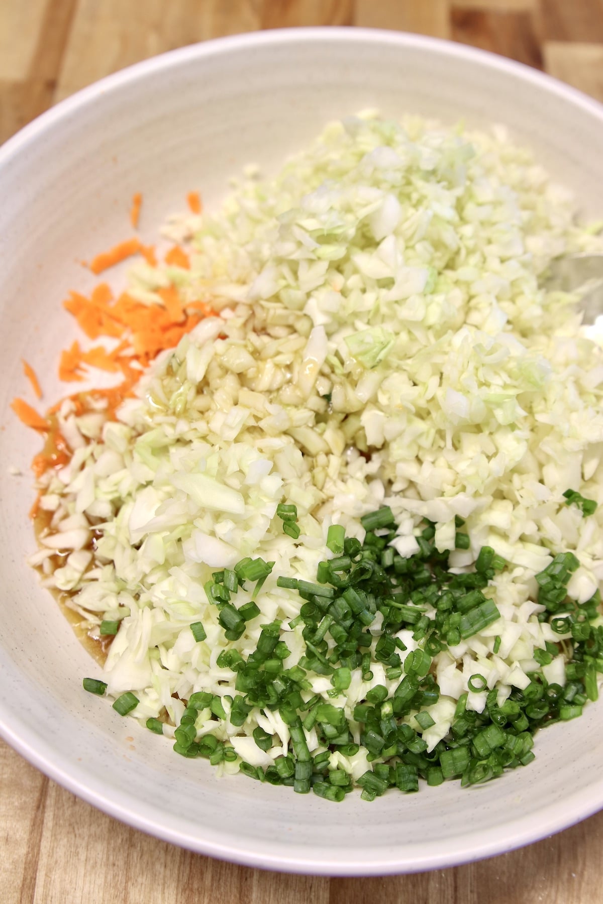 Slaw with green onions in a bowl. 