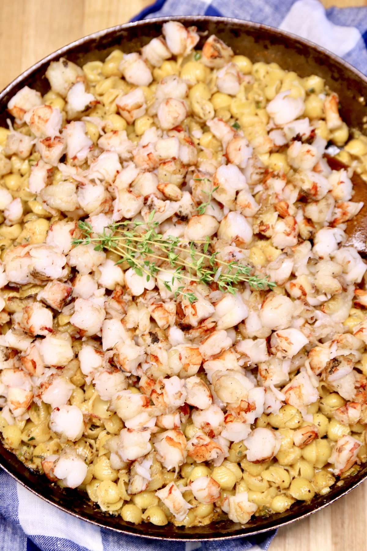Closeup of skillet with Cajun pasta and shrimp.